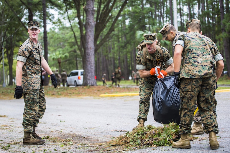 Marines clear debris from a main road aboard Marine Corps Air Station Beaufort Oct. 8. Marines and sailors with MCAS Beaufort worked to return the air station and Laurel Bay to normal operations. They removed debris and cleaned up main access roads to establish infrastructure after Hurricane Matthew.