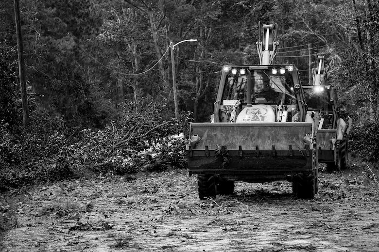 Marines use heavy equipment to clear roads aboard Marine Corps Air Station Beaufort Oct. 8. Marines and sailors with MCAS Beaufort worked to remove debris and establish infrastructure aboard the air station and Laurel Bay after Hurricane Matthew. 