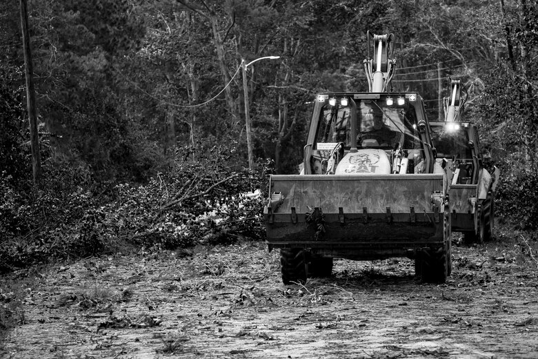 Marines use heavy equipment to clear roads aboard Marine Corps Air Station Beaufort Oct. 8. Marines and sailors with MCAS Beaufort worked to remove debris and establish infrastructure aboard the air station and Laurel Bay after Hurricane Matthew. 