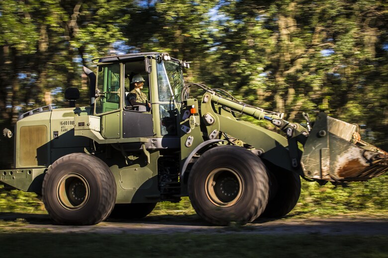 A Marine uses heavy equipment to remove a tree on a road aboard Marine Corps Air Station Beaufort Oct. 9. Marines and sailors with MCAS Beaufort continued to work to remove debris and establish infrastructure aboard the air station and Laurel Bay after Hurricane Matthew. 