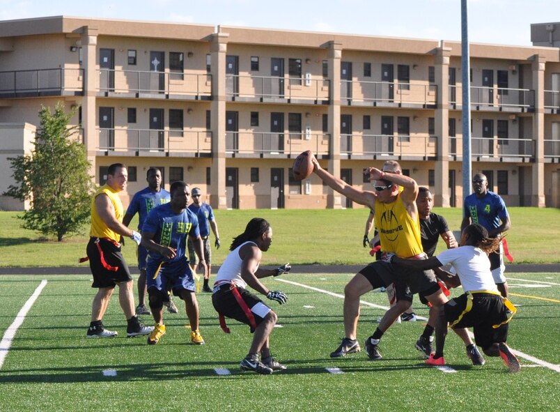 Reserve Gold’s Jacob Bacon threads the needle between two 424th SCMS defenders Sept. 27 in intramural flag football. Reserve Gold improved its record to 4-0 last week after winning the game 14-0.  (Air Force photo by John Parker)