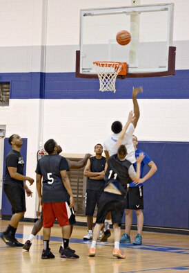 Staff Sgt. Deante Covington, with the 965th Airborne Air Control Squadron, goes up for a lay-up to score two points for their 3-on-3 match-up against the 72nd Security Forces Squadron. (Air Force photo by Kelly White)