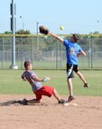 Staff Sgt. Justin Laing, with the 552nd Maintenance Group’s Aerospace Ground Equipment shop, slides safely into second base as Senior Airman Tyler Starr, with the 72nd Operations Support Squadron’s softball team, barely misses a long throw from the outfield. (Air Force photo by Kelly White)