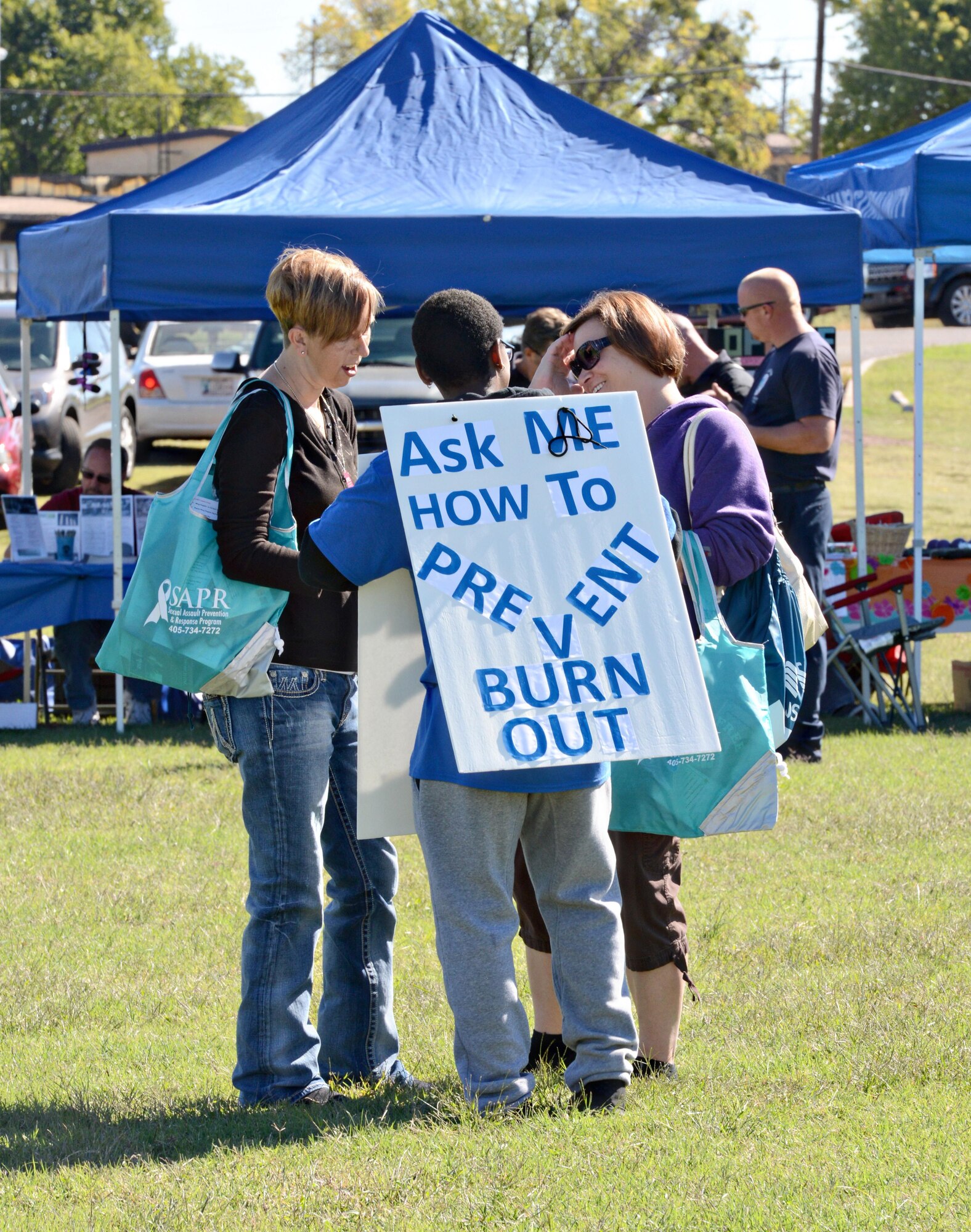 Several volunteers walked around the Sports and Resiliency Day field wearing “sandwich boards” and gave out valuable information about being resilient. (Air Force photo by Kelly White)