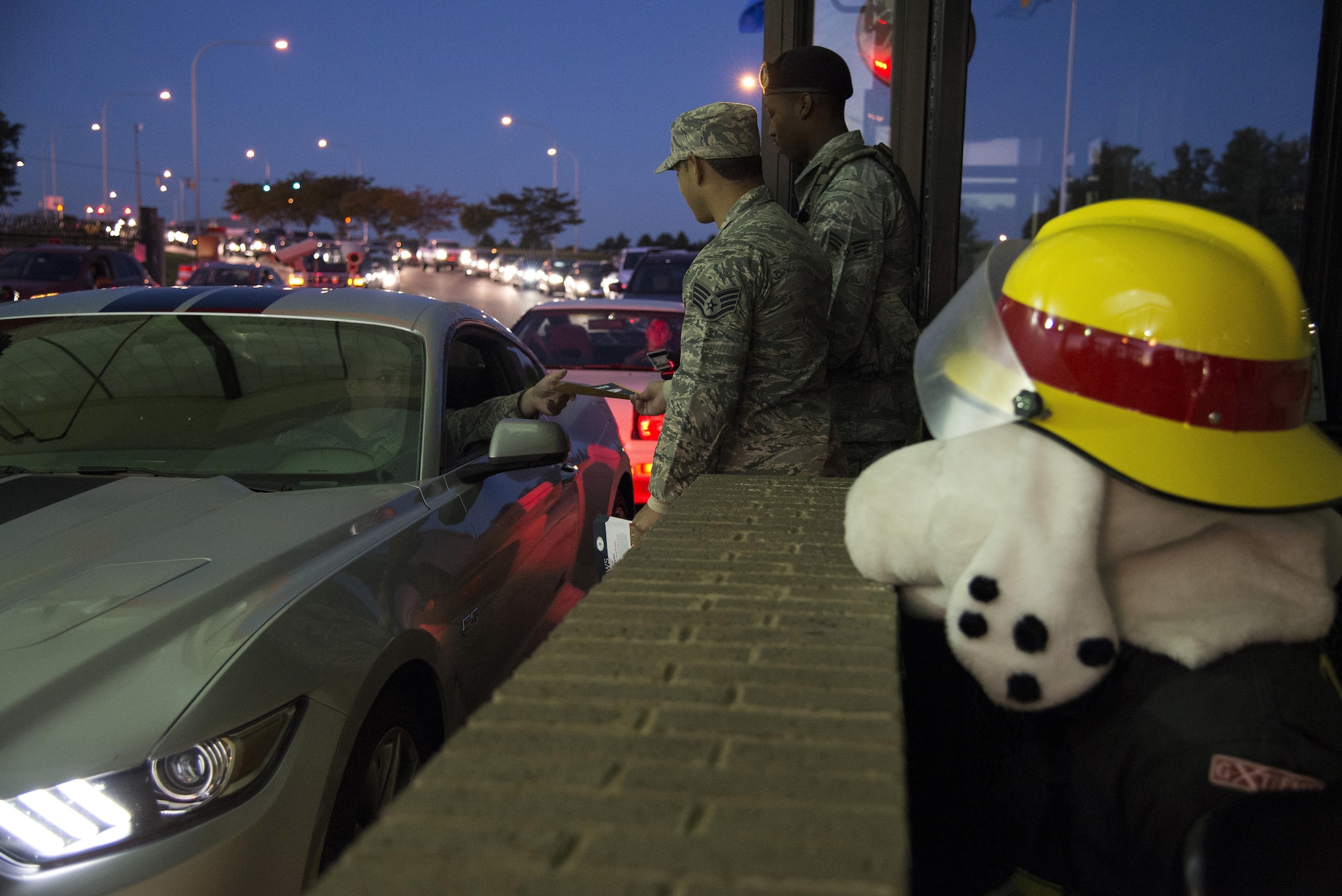 Staff Sgt. Julio Madera, 436th Civil Engineer Squadron Fire Department lead fire inspector, hands out Fire Prevention Week pamphlets, as Sparky the Fire Dog watches, at the main gate of Dover Air Force Base, Del., Oct. 11, 2016. This year’s Fire Prevention Week theme is titled: “Don’t Wait – Check the Date! Replace Smoke Alarms Every 10 Years.” (U.S. Air Force photo by Senior Airman Aaron J. Jenne)