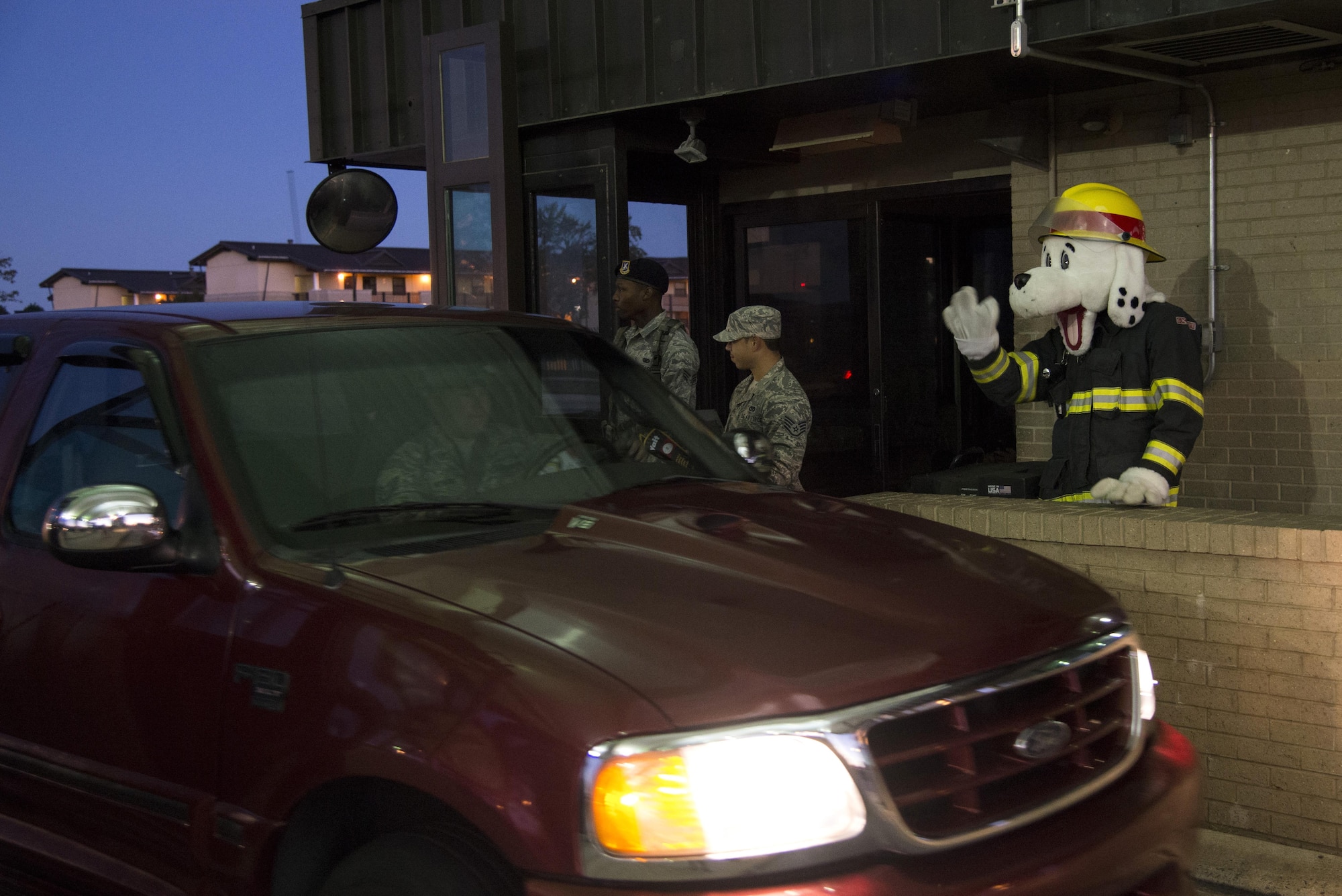 Sparky the Fire Dog waves to an Airman driving through the main gate Oct. 11, 2016, at Dover Air Force Base, Del. This event was intended to kick off the installation’s Fire Prevention Week observances, including the ‘Battle of the Badges’ softball game, Fire Muster team building event and the Fire Department Open House. (U.S. Air Force photo by Senior Airman Aaron J. Jenne)