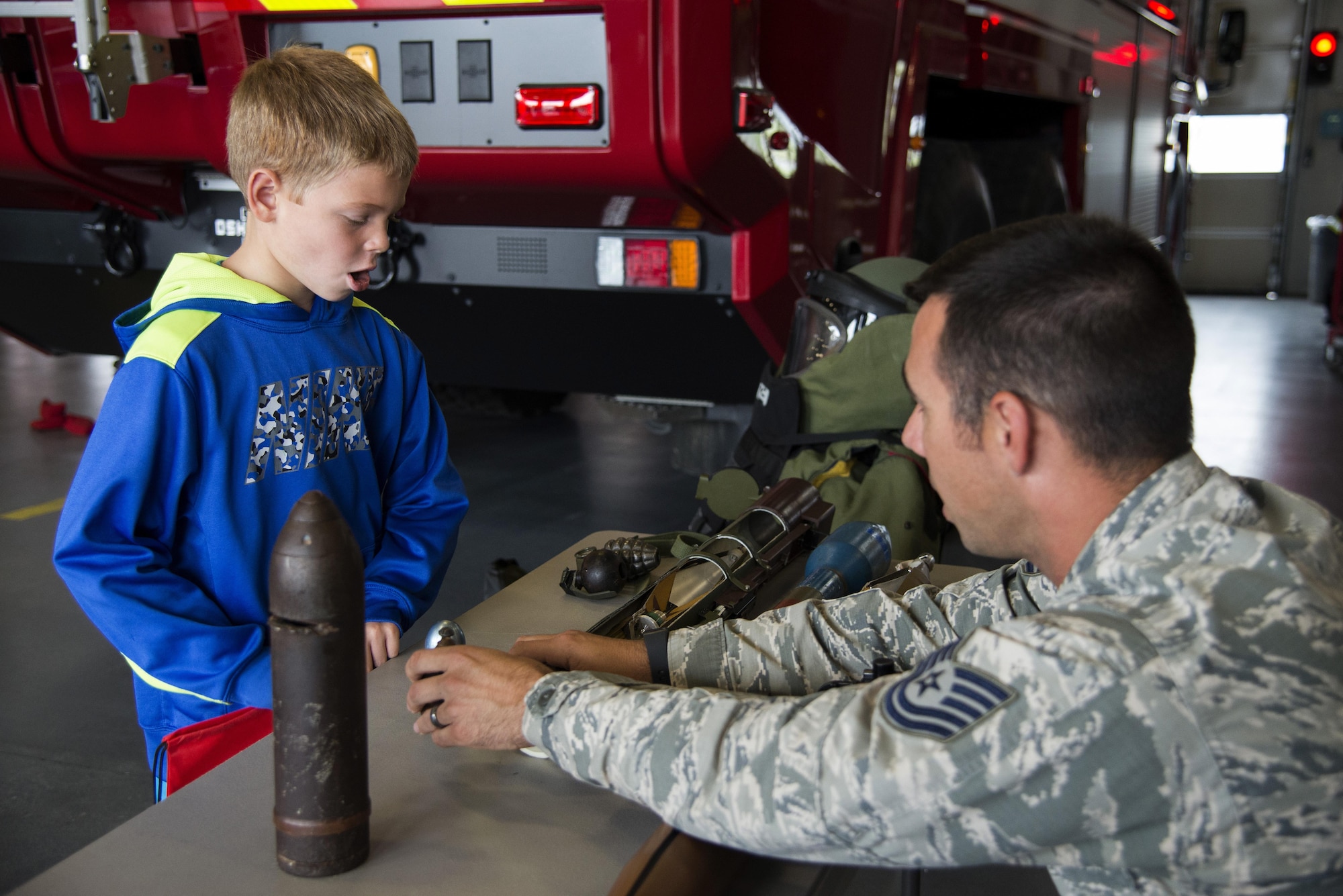 Tech. Sgt. Donald Manuel, 436th Civil Engineer Squadron explosives ordnance disposal craftsman, explains his job to Merric Hunt, son of Master Sgt. Adam Hunt, 436th Maintenance Squadron Isochronal Maintenance Dock chief, during the Dover Air Force Base First Responders’ Special Needs Day Oct. 8, 2016, at the 436th Civil Engineer Squadron Fire Department on Dover AFB, Del. Members of the 436th CES EOD, 436th Security Forces Squadron and 436th Medical Group set up displays and provided tours of their emergency response vehicles. (U.S. Air Force photo by Senior Airman Aaron J. Jenne)