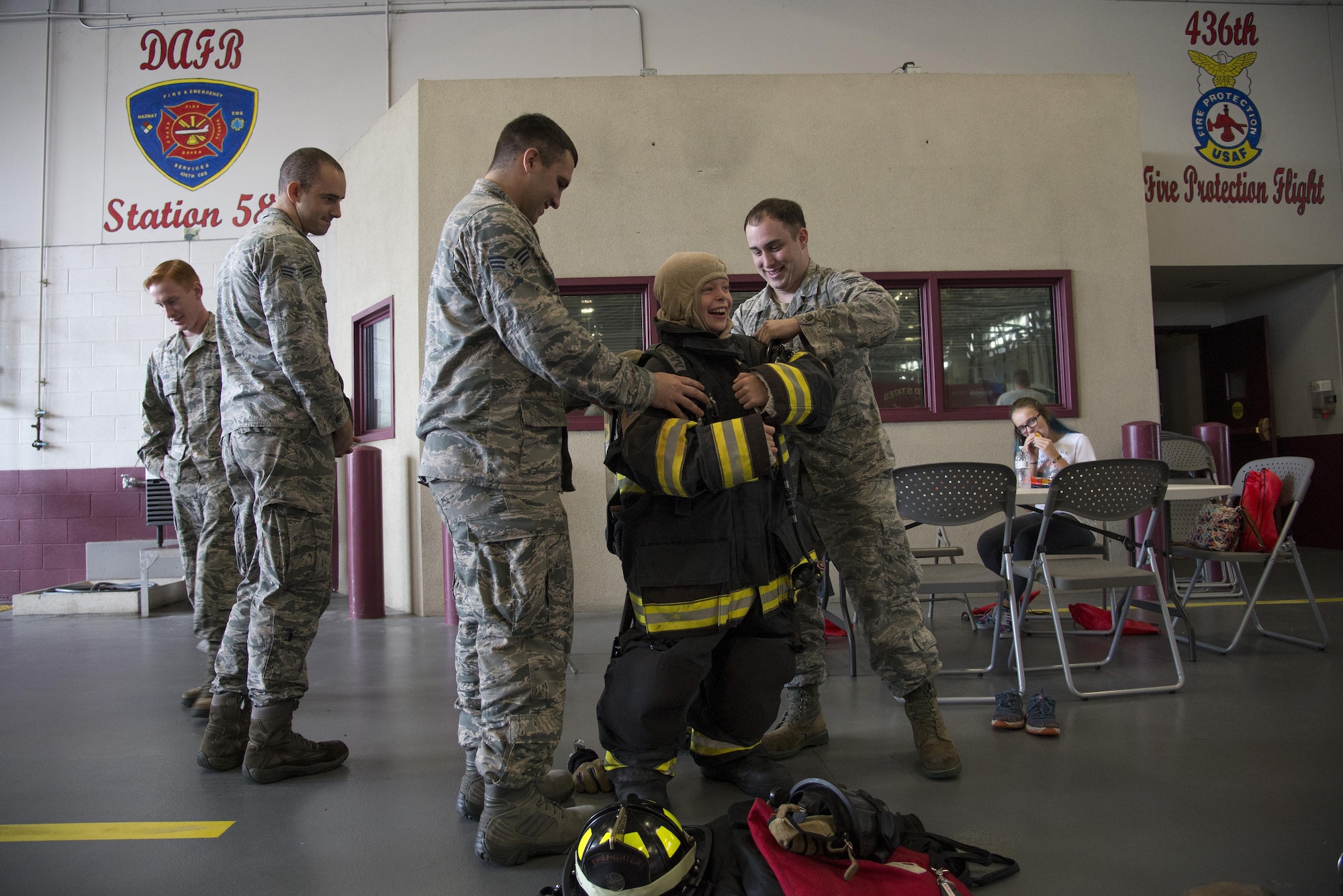 Senior Airmen James Marker and Jamie Perigny, 436th Civil Engineer Squadron firefighters, help Merric Hunt, son of Master Sgt. Adam Hunt, 436th Maintenance Squadron Isochronal Maintenance Dock chief, try on firefighting bunker gear during the Dover Air Force Base First Responders’ Special Needs Day Oct. 8, 2016, at the 436th CES Fire Department on Dover AFB, Del. Event attendees had the opportunity to try on equipment, tour emergency response vehicles and learn something new about first responders. (U.S. Air Force photo by Senior Airman Aaron J. Jenne)