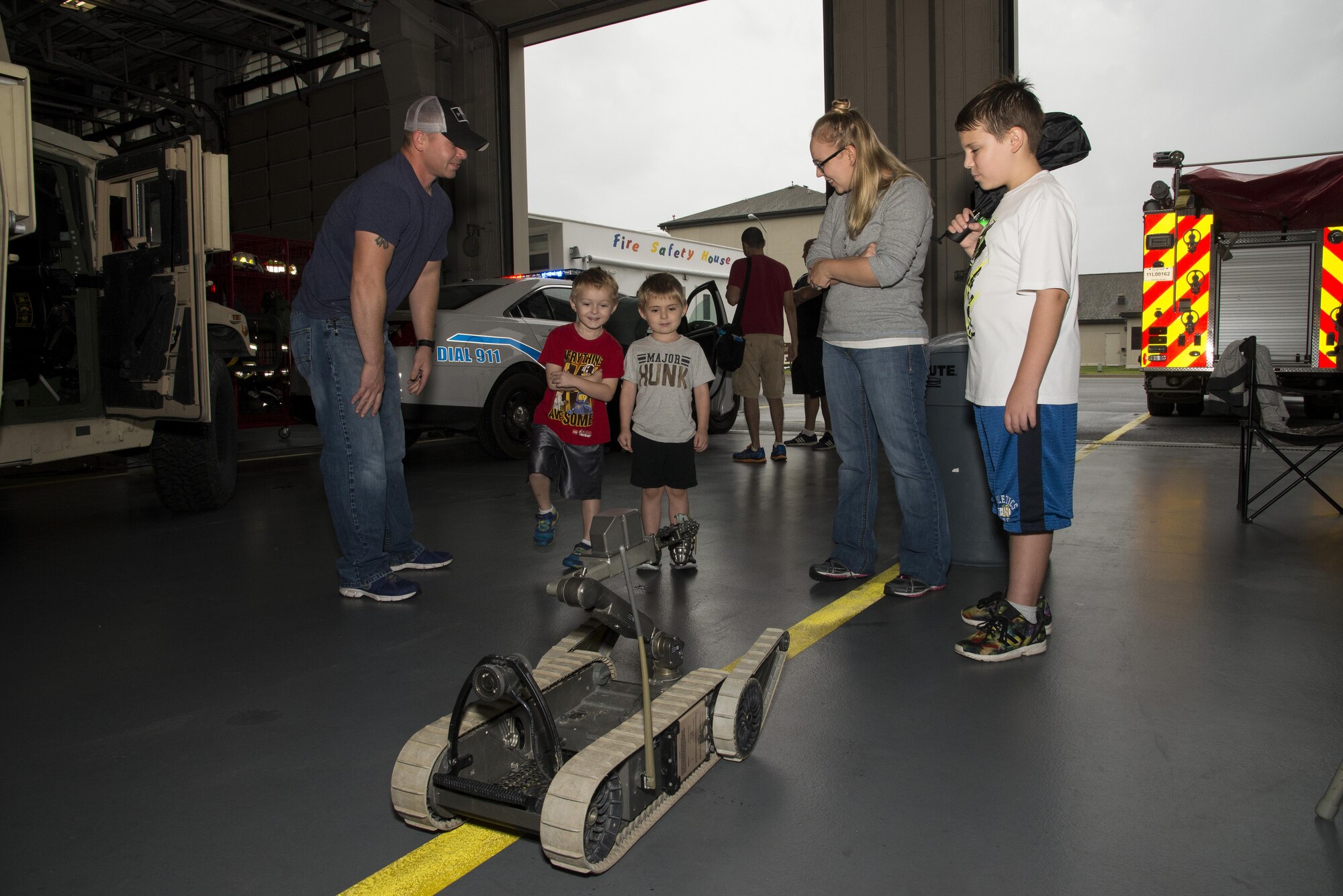 Attendees of the Dover Air Force Base First Responders’ Special Needs Day watch a demonstration of a 436th Civil Engineer Squadron Explosive Ordnance Disposal robot Oct. 8, 2016, at the 436th CES Fire Department on Dover AFB, Del. More than 25 members of Team Dover attended the event where they were able to interact with emergency responders, vehicles and equipment. (U.S. Air Force photo by Senior Airman Aaron J. Jenne)