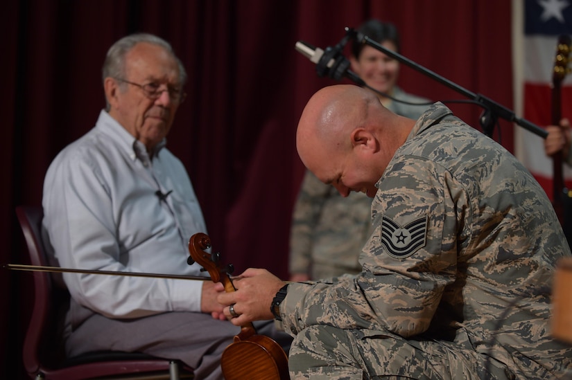 Members of the U.S. Air Force Heritage of America Band, Blue Aces laugh along with Bobby Wheeler, a veteran in the music therapy program at Salem Veteran Affairs Medical Center, after Wheeler told a funny story at the Salem VA Medical Center in Salem, Va., Sept. 27, 2016. Wheeler, despite having a few disabilities such as not always remembering which way to pick up the fiddle, has not lost his ability to tell a joke. Members of the Blue Aces had the opportunity to experience his humor during their one-on-one performance session. (U.S. Air Force photo by Senior Airman Kimberly Nagle)