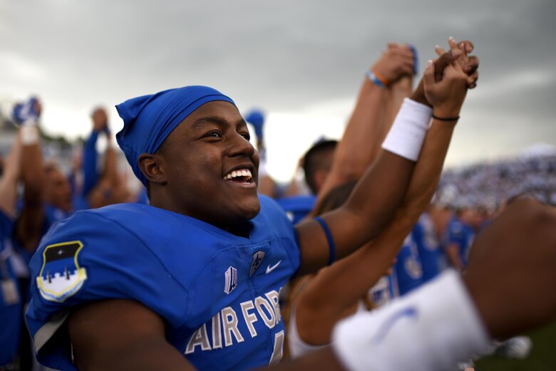 U.S. AIR FORCE ACADEMY, Colo. – Cadet 3rd Class Ronald Cleveland, U.S. Air Force Academy football team wide receiver, celebrates with teammates and fans in Falcon Stadium at the U.S. Air Force Academy, Colo., Oct. 1, 2016. The Air Force Falcons continue their undefeated season after overpowering the Navy Midshipmen with a final score of 28 - 14. (U.S. Air Force photo by Airman 1st Class Dennis Hoffman)