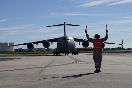 Col. Jimmy Canlas, 437th Airlift Wing commander, marshals in the first C-17 Globemaster III returning to Joint Base Charleston on Oct. 11 after evacuating for Hurricane Matthew. Many of the aircraft continued to perform various world-wide missions from their evacuated locations. 