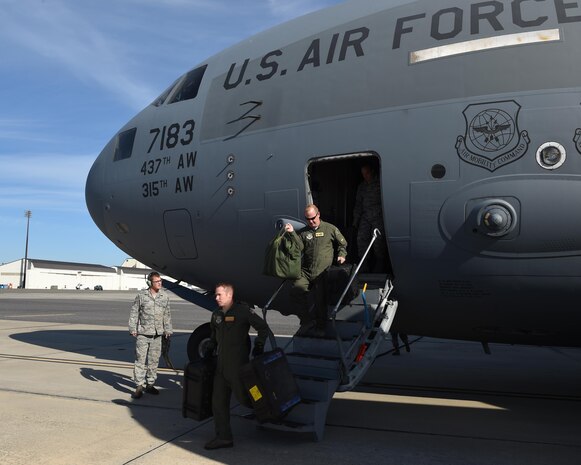 16th Airlift Squadron aircrew members disembark from the first C-17 Globemaster III returning to Joint Base Charleston on Oct. 11 after evacuating for Hurricane Matthew. JB Charleston aircraft evacuated to four different locations: Barksdale Air Force Base, Louisiana; Wright Patterson Air Force Base, Ohio; Fort Campbell, Kentucky and Thompson Field in Jackson, Mississippi, where the aircraft were able to perform various rapid mobility missions. 