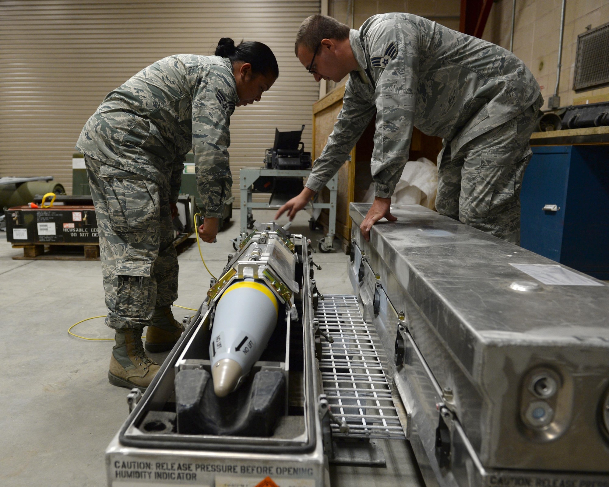 U.S. Air Force Senior Airmen Andrew Tree and Loreal Duque, 325th Maintenance Squadron munitions systems specialists, perform software update maintenance on a weapon system at Tyndall Air Force Base, Fla., Oct. 4, 2016. Munitions can be optimized by software upgrades, much like many consumer electronics. Updating the software on the Air Force’s weapons systems is one way the U.S. military maintains air superiority. (U.S. Air Force photo by Airman 1st Class Cody R. Miller/Released)