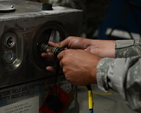 A 325th Maintenance Squadron munitions systems specialist connects an uplink cable while performing maintenance on a weapon system at Tyndall Air Force Base, Fla., Oct. 4, 2016. Munitions systems specialists are tasked with handling, storing, transporting, arming and disarming non-nuclear weapons systems. (U.S. Air Force photo by Airman 1st Class Cody R. Miller/Released)