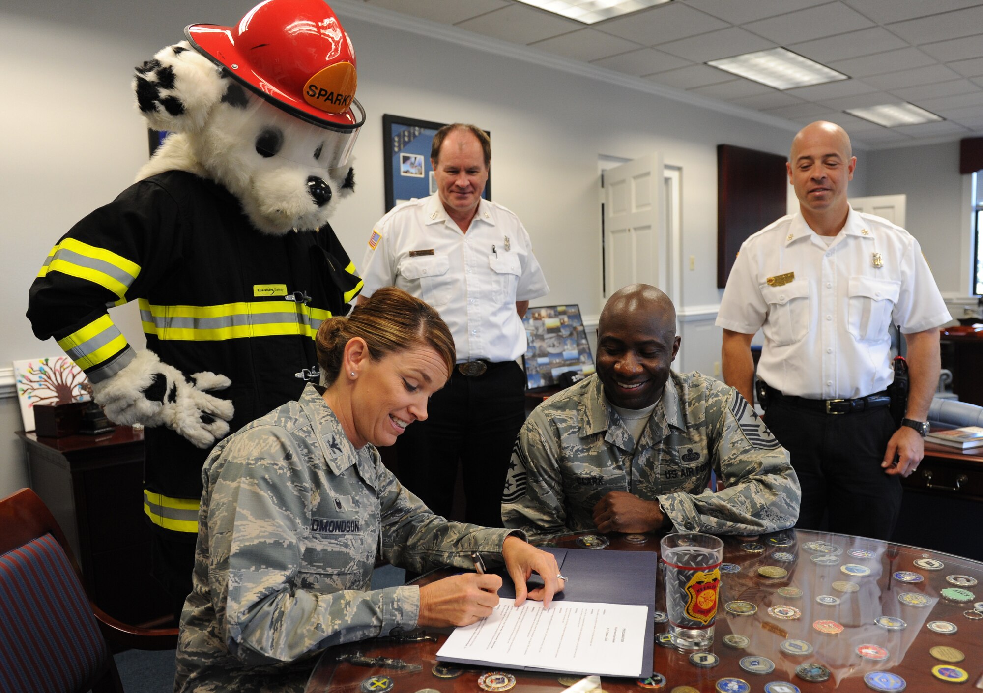 Col. Michele Edmondson, 81st Training Wing commander, signs the Fire Prevention Week Declaration at the 81st TRW headquarters building Oct. 11, 2016, on Keesler Air Force Base, Miss. The weeklong event includes fire drills, literature hand-outs and stove fire demonstrations around the base and concludes with an open house at the fire department Oct. 15. (U.S. Air Force photo by Kemberly Groue/Released)