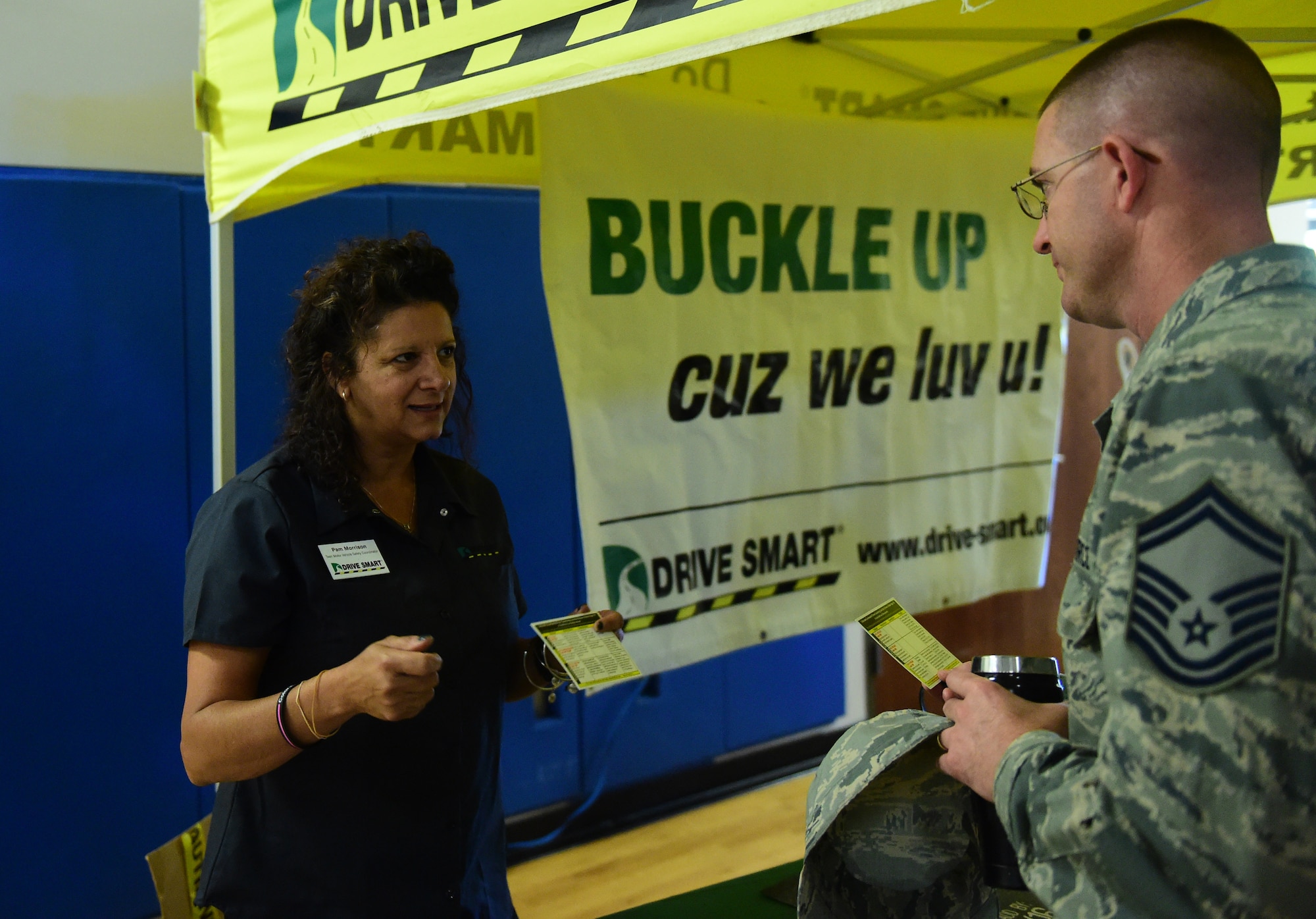 A Drive Smart Colorado team member discusses seat belt safety with Senior Master Sgt. Kristopher Coats, 460th Comptroller Squadron superintendent, during a Safety Day event Oct. 7, 2016, at the fitness center on Buckley Air Force Base, Colo. Drive Smart Colorado, a program designed to reduce the number of traffic crashes through community collaboration and education, provided information on their different programs to Team Buckley during the daylong event. (U.S. Air Force photo by Airman 1st Class Gabrielle Spradling/Released)