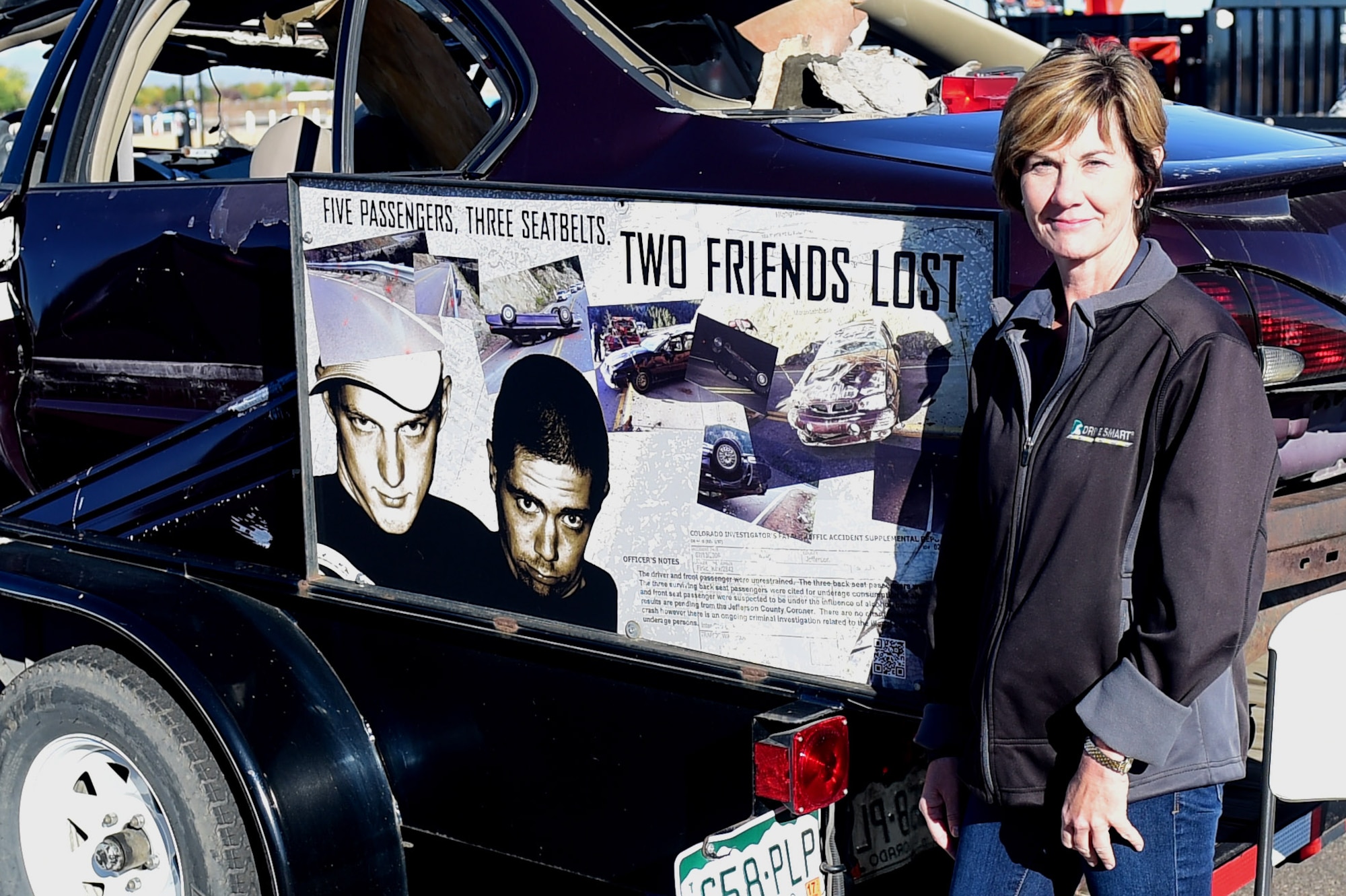 Amy Nichols, Brandon and Paul Foundation executive director, stands beside the car in which her son was killed in during a Safety Day event Oct. 7, 2016, at the fitness center on Buckley Air Force Base, Colo. Nichols lost her son during a drunk driving accident and hopes that by telling her story people will think twice before drinking and driving. (U.S. Air Force photo by Airman 1st Class Gabrielle Spradling/Released)
