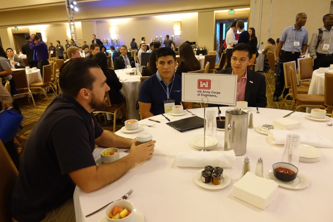 During the “Speed Networking Breakfast” on Oct. 7, employees discuss career opportunities with engineering students and recent college graduates.  Brandon Whitley (left), USACE LA district civil engineer intern, chats with Alejandro Gonzales (middle), a civil engineer student at New Mexico State University and Edward Baca (right), a mechanical engineer student at the University of Texas - Austin.   Whitley, a Cal Poly Pomona graduate spoke about the LA River and Prado Dam and the significant role the Corps plays in civil works programs.