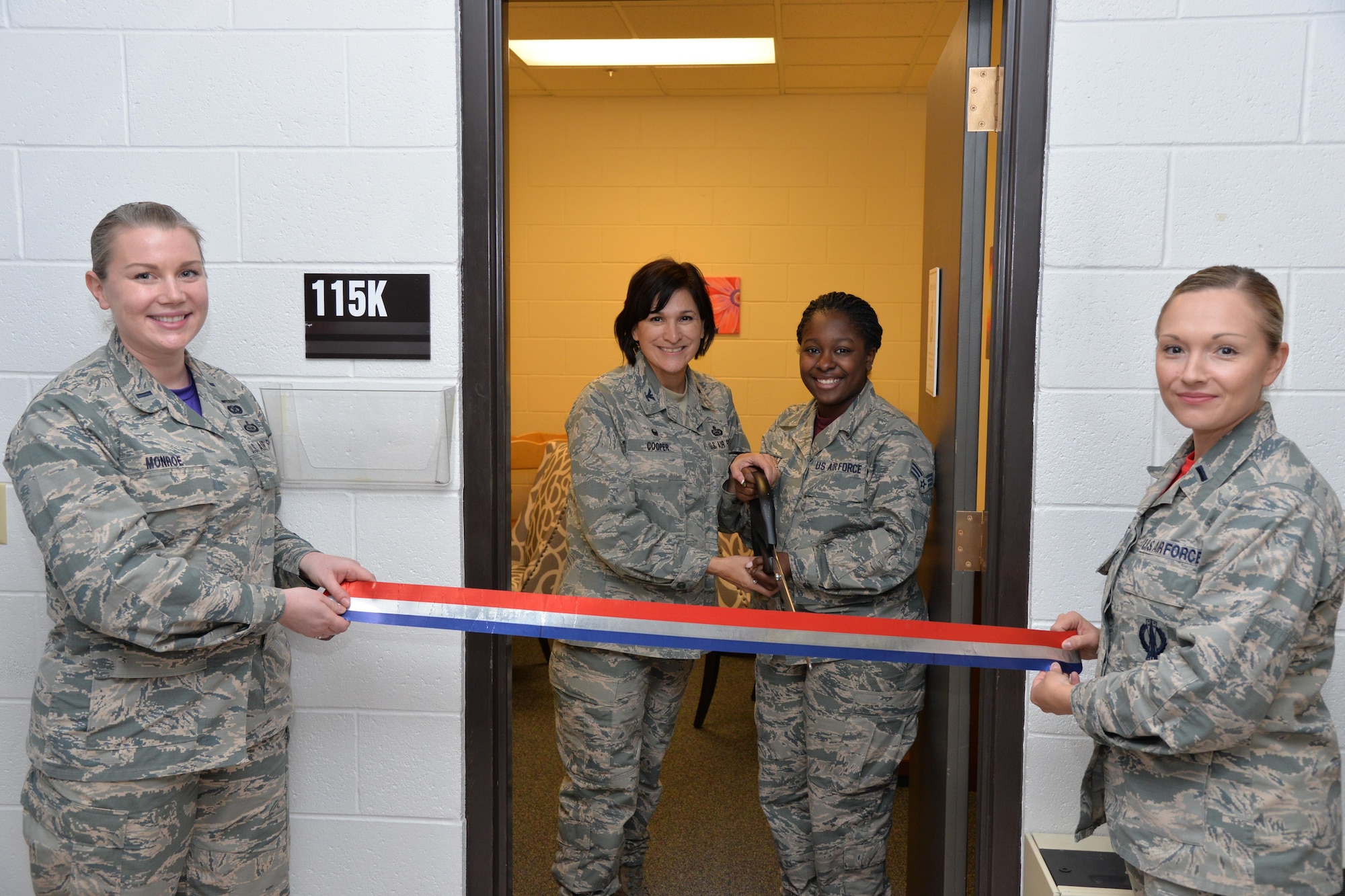 1st Lt. Annabel Monroe, 341st Missile Wing public affairs officer, left, and 1st Lt. Shelia Koebel, 12th Missile Squadron missile combat crew commander, right, hold a ribbon for Col. Denise Cooper, 341st Mission Support Group commander, and Senior Airman LaKayla Bennett, 741st Maintenance Squadron administrator, to cut at Malmstrom Air Force Base, Mont., Oct. 17, 2016. The room is one of six newly renovated spaces for mothers to breast-feed or pump in a secure and clean environment. (U.S. Air Force photo/Airman 1st Class Daniel Brosam)