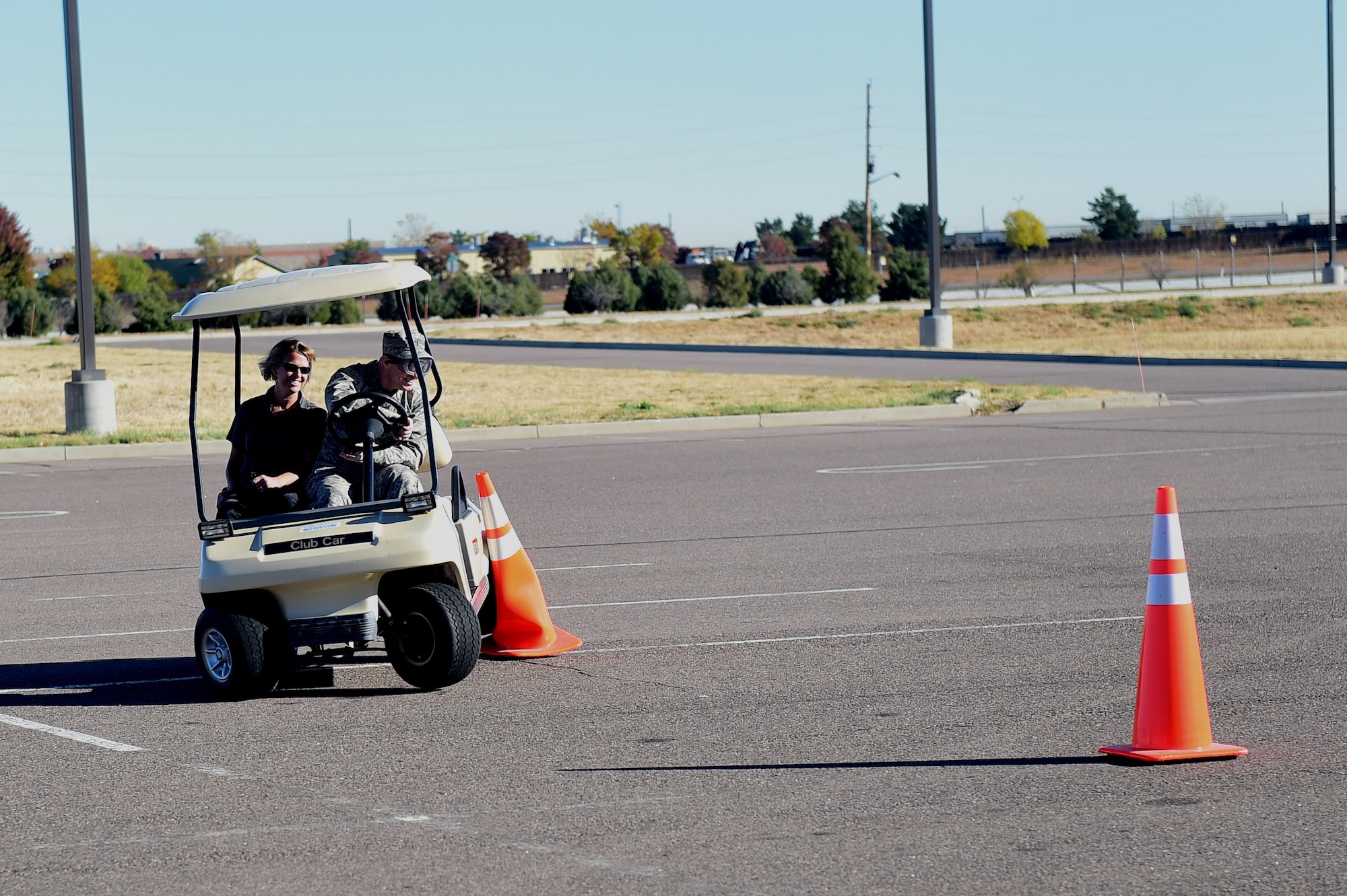 A member of Team Buckley tries to drive a golf cart while wearing drunk goggles during a Safety Day event Oct. 7, 2016, at the fitness center on Buckley Air Force Base, Colo. The event included hunting and outdoor safety, home and fire safety and hands-on activities for driving safety. (U.S. Air Force photo by Airman 1st Class Gabrielle Spradling/Released)