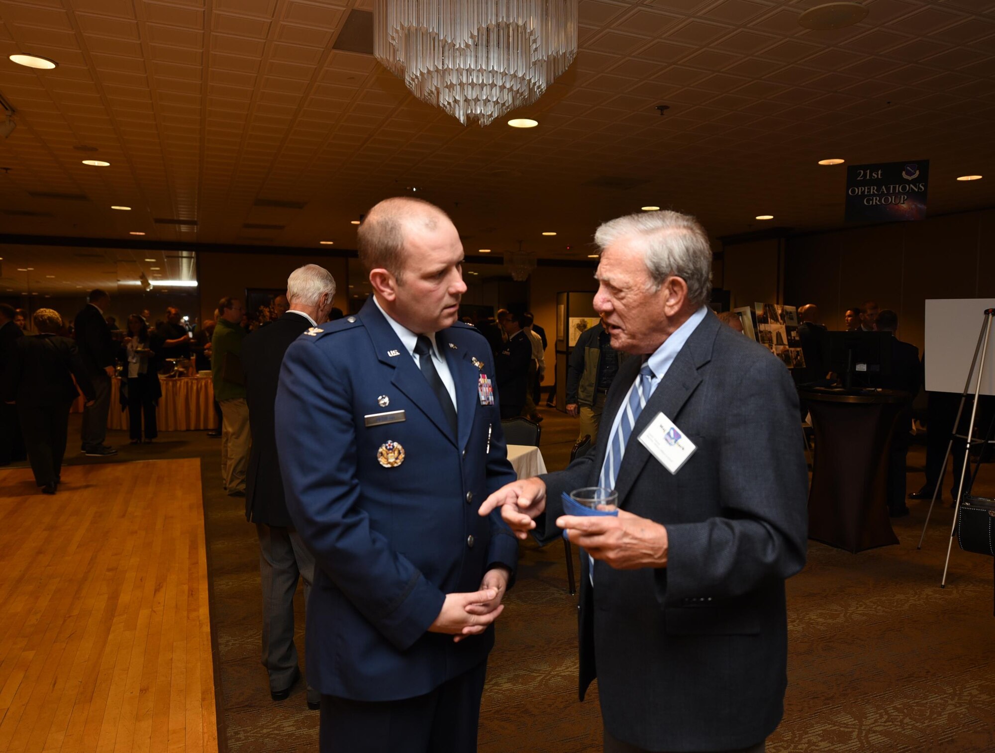 PETERSON AIR FORCE BASE, Colo. – 21st Space Wing Commander Col. Doug Schiess discusses a point from his State of the Wing address with retired Maj. General Wes Clark, former vice commander of Air Force Space Command. Schiess presented the address to community leaders Thursday, Oct. 6 as a review of his first year in command, as well as a glimpse into the upcoming year. (U.S. Air Force Photo by Philip Carter)