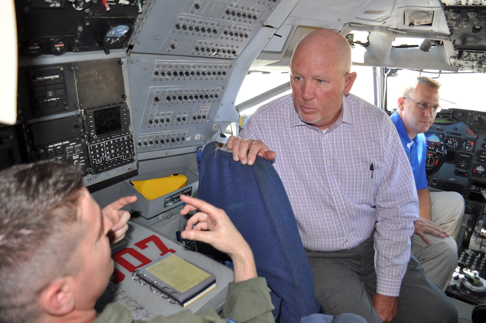 552nd Air Control Wing Honorary Commander Roger Ford listens as 1st Lt. David Russo, a navigator with the 960th Airborne Air Control Squadron, describes the navigation equipment on the E-3 sentry aircraft. The honorary commanders meeting took place Sept. 28.   (Air Force photo by Ron Mullan) 