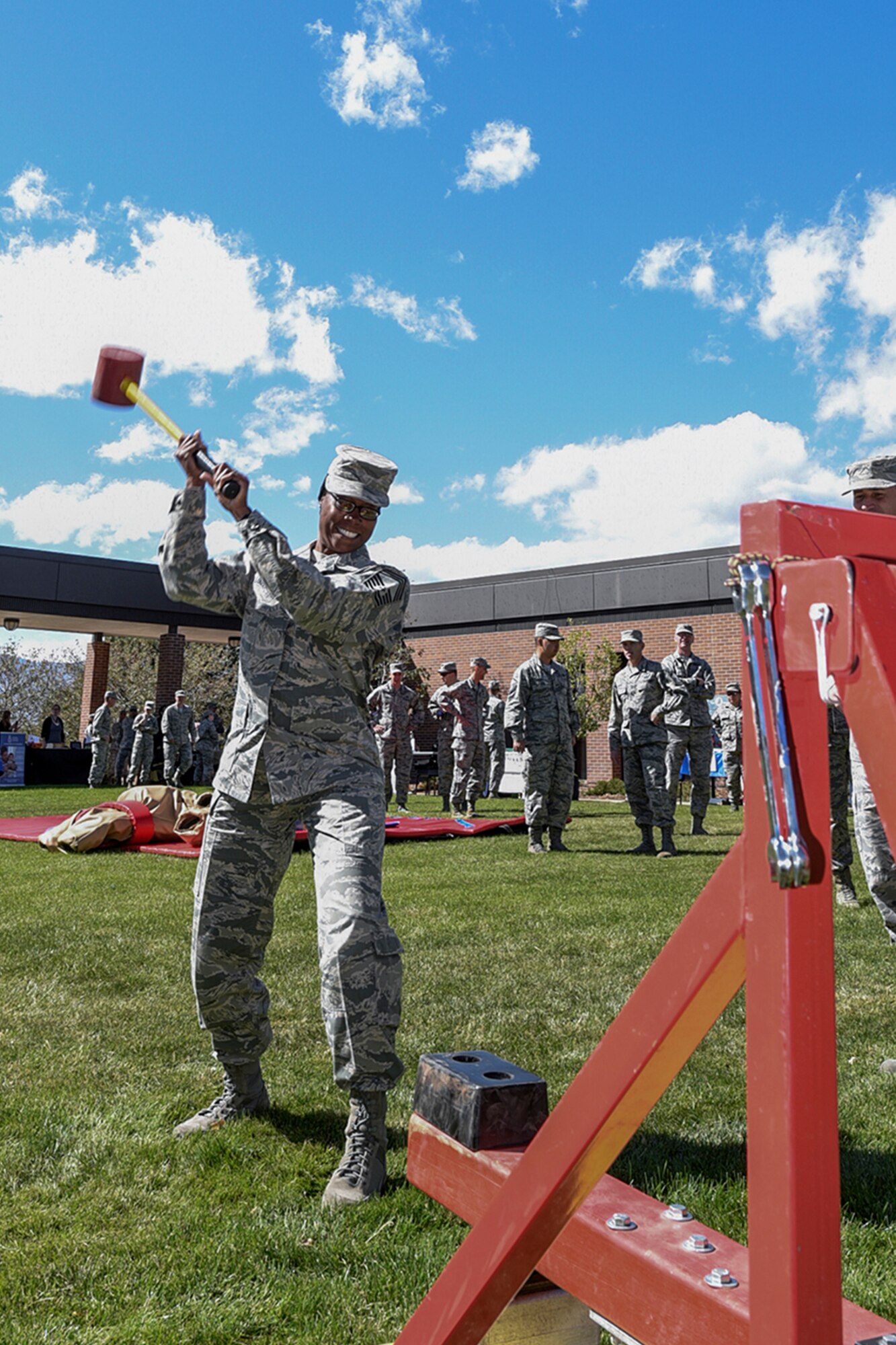 PETERSON AIR FORCE BASE, Colo. – Chief Master Sgt. Nanette Klingaman, 721st Mission Support Group command chief, swings a hammer to ring the bell at the Combined Federal Campaign kickoff event at Peterson Air Force Base, Colo., Oct. 5, 2016. The 21st Space Wing annual CFC kickoff consisted of a carnival and information fair, which provided Airmen with general knowledge about different organizations to support. (U.S. Air Force photo by Philip Carter)
