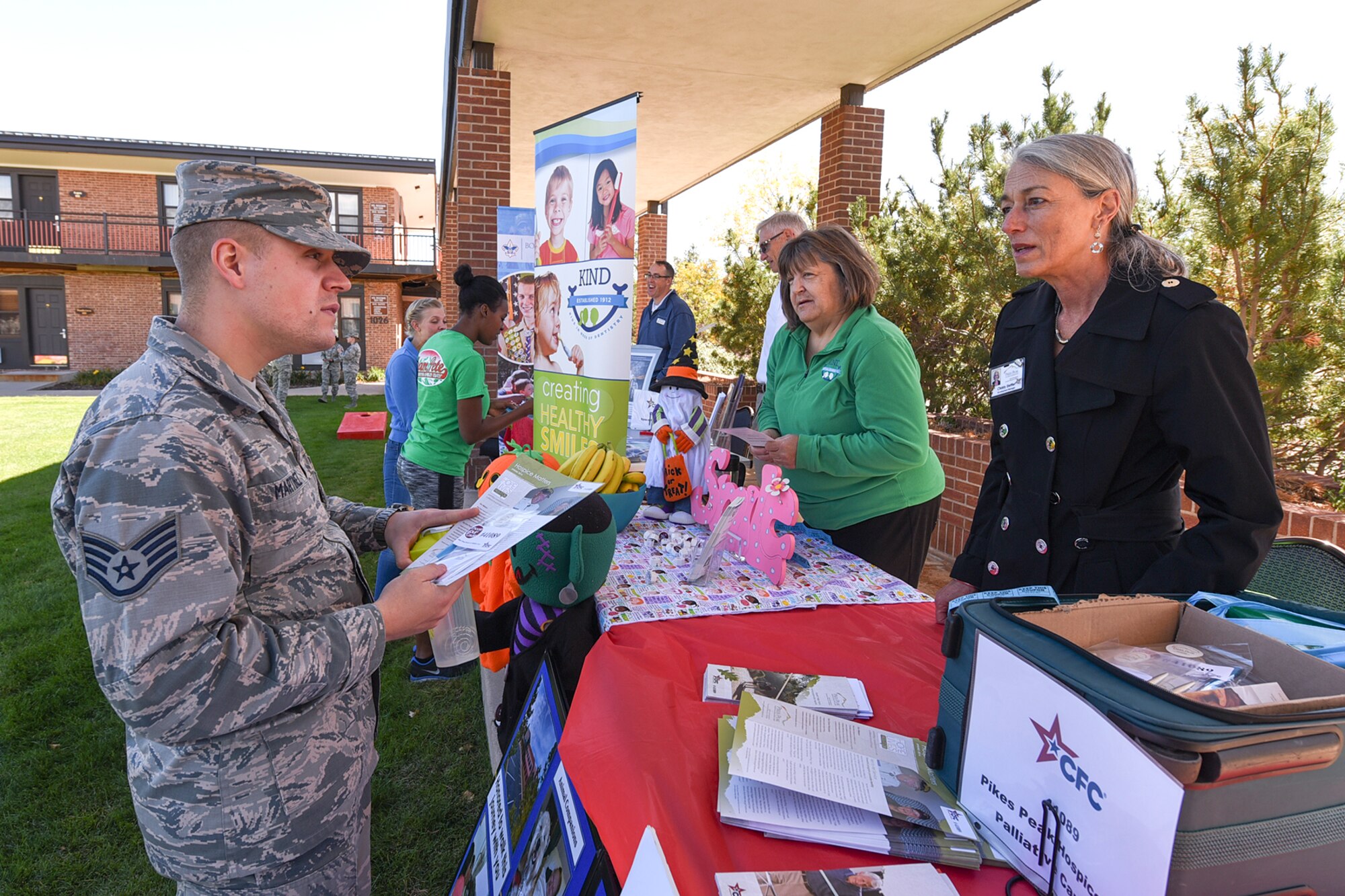PETERSON AIR FORCE BASE, Colo. - Staff Sgt. Sven Martinez, 21st Comptroller Squadron budget analyst, asks Christy Stettler, Pikes Peak Hospice Palliative Care representative, about their organization during the Combined Federal Campaign Kickoff Event at The Club on Peterson Air Force Base, Colo., Oct. 5, 2016.  The 21st Space Wing annual CFC kickoff consisted of a carnival and information fair, which provided Airmen with general knowledge about different organizations to support. (U.S. Air Force photo by Philip Carter)