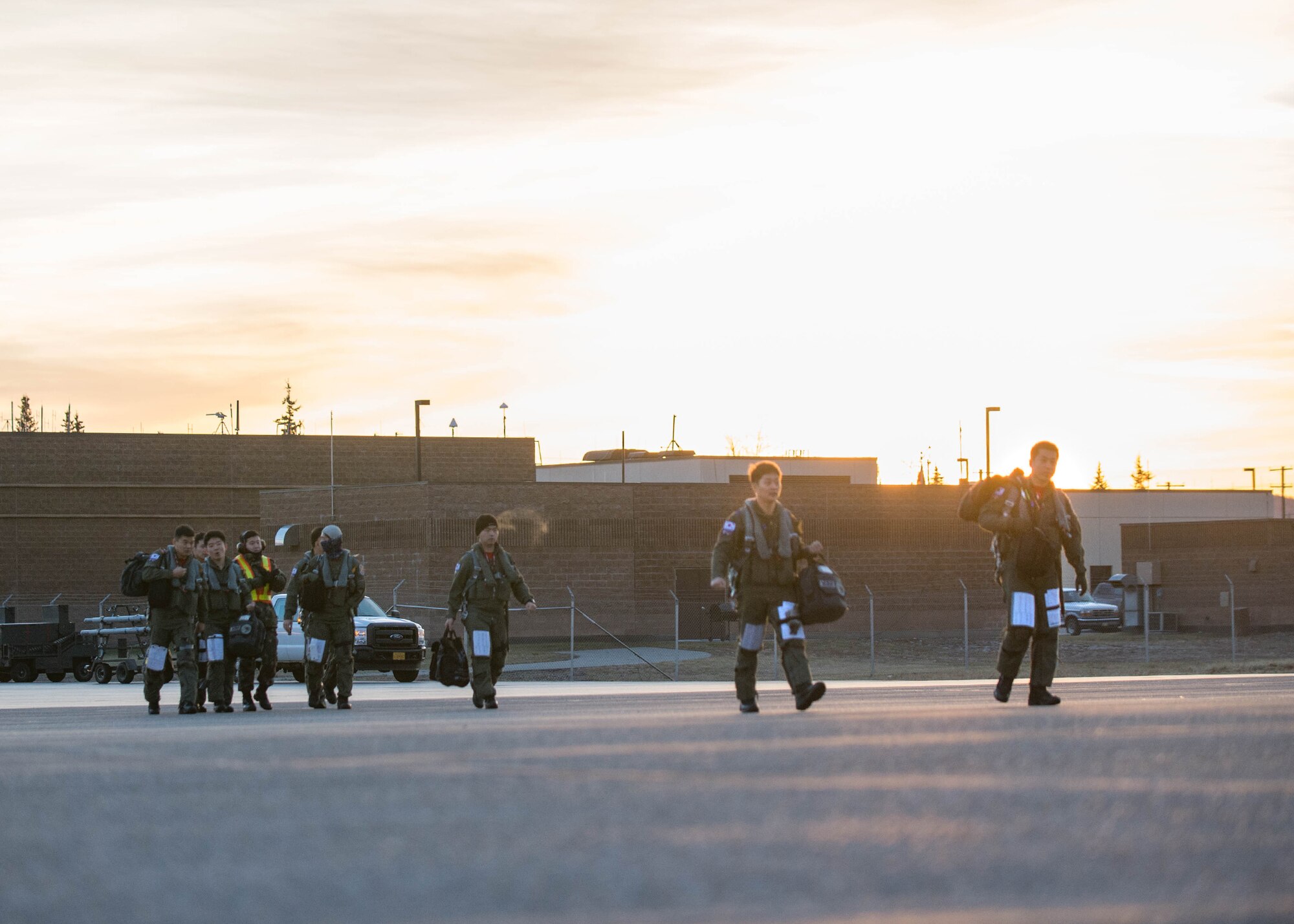 Republic of Korea Air Force (ROKAF) F-15K Slam Eagle pilots and weapons officers walk to their jets for a mission Oct. 11, 2016, during RED FLAG-Alaska (RF-A) 17-1 at Eielson Air Force Base, Alaska. They used a laser guided GBU-54 bomb for the first time on a ROKAF F-15K Slam Eagle fighter aircraft. Exercise scenarios occur within the Joint Pacific Alaska Range Complex, a more than 67,000 square mile airspace, with minimal impact on the environment. (U.S. Air Force photo by Staff Sgt. Shawn Nickel)