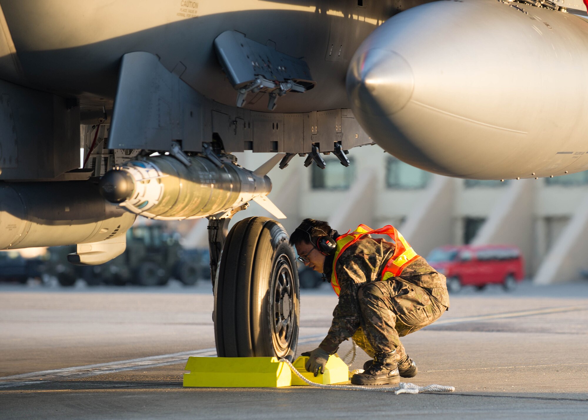 A maintenance airman from the Republic of Korea Air Force pulls the chalks from an F-15K Slam Eagle fighter aircraft prior to take off Oct. 11, 2016, during RED FLAG-Alaska (RF-A) 17-1 at Eielson Air Force Base, Alaska. This Pacific Air Forces commander-directed exercise is vital to maintaining peace and stability in the Indo-Asia-Pacific region. (U.S. Air Force photo by Staff Sgt. Shawn Nickel)