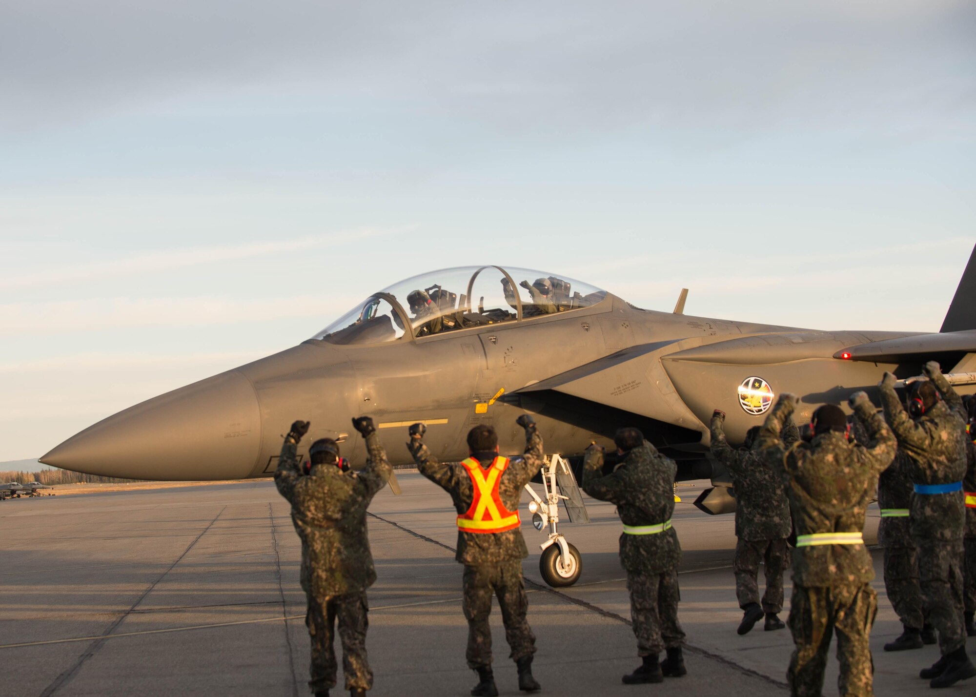 Maintenance airmen from the Republic of Korea Air Force cheer for the crew of an F-15K Slam Eagle fighter aircraft as it leaves for a flight Oct. 11, 2016, during RED FLAG-Alaska (RF-A) 17-1 at Eielson Air Force Base, Alaska. RF-A provides training for deployed maintenance and support personnel in sustainment of large-force deployed air operations. (U.S. Air Force photo by Staff Sgt. Shawn Nickel)
