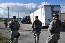 Staff Sgt. Ryan Ernst, Staff Sgt. Jefrey Davis, and Senior Airman Hans Houser, 4th Space Operations Squadron mobile team, escort the Advanced Ground Mobile space operating semitrailer to the Hawaii exercise operating location. Mobile team members are required to be trained and weapons qualified to defend the assets in contingency situations. (U.S. Air Force photo/2nd Lt. Darren Domingo)