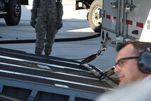 Loading crews observe a winch pulling the Advanced Ground Mobile onto the ramp of a C-17 Globemaster III. During the loading process, skilled drivers must maneuver the AGM within an accuracy area of just a few inches, taking care not to damage the plane or semitrailer. (U.S. Air Force photo/2nd Lt. Darren Domingo)
