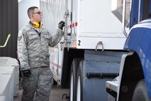 Staff Sgt. Jefrey Davis, 4th Space Operations Squadron mobile flight shelter maintainer, secures the Advanced Ground Mobile satellite operations center before flight. The full-sized semitrailer is a fully operating space operations control center that operates Milstar and Advanced Extremely High Frequency satellite constellations, a highly protected military satellite communications network. (U.S. Air Force photo/2nd Lt. Darren Domingo)