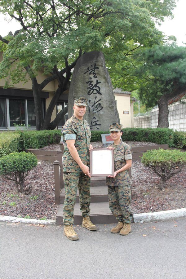 Newly pinned Gunnery Sergeant Shasta Hollins, a Personnel Chief, with U. S. Marine Corps Forces Korea stands with SgtMaj Moran following her promotion ceremony in front of the MARFORK Headquarters building aboard USAG Yongsan Seoul, South Korea.