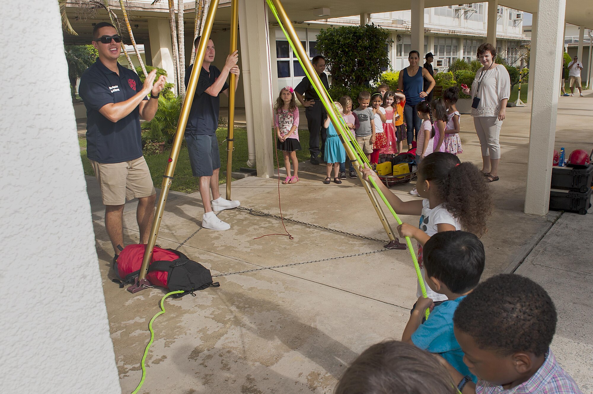 Children at Kadena Elementary School use a pulley system to easily move a heavy stretcher with a dummy on it during fire prevention week Oct. 5, 2016, at Kadena Air Base, Japan. Kadena firefighters brought their trucks, equipment and smoke trailer to the schools on base to teach kids the importance of fire safety, how to check smoke alarms and what to do in the case of a fire. (U.S. Air Force photo by Airman 1st Class Corey M. Pettis)