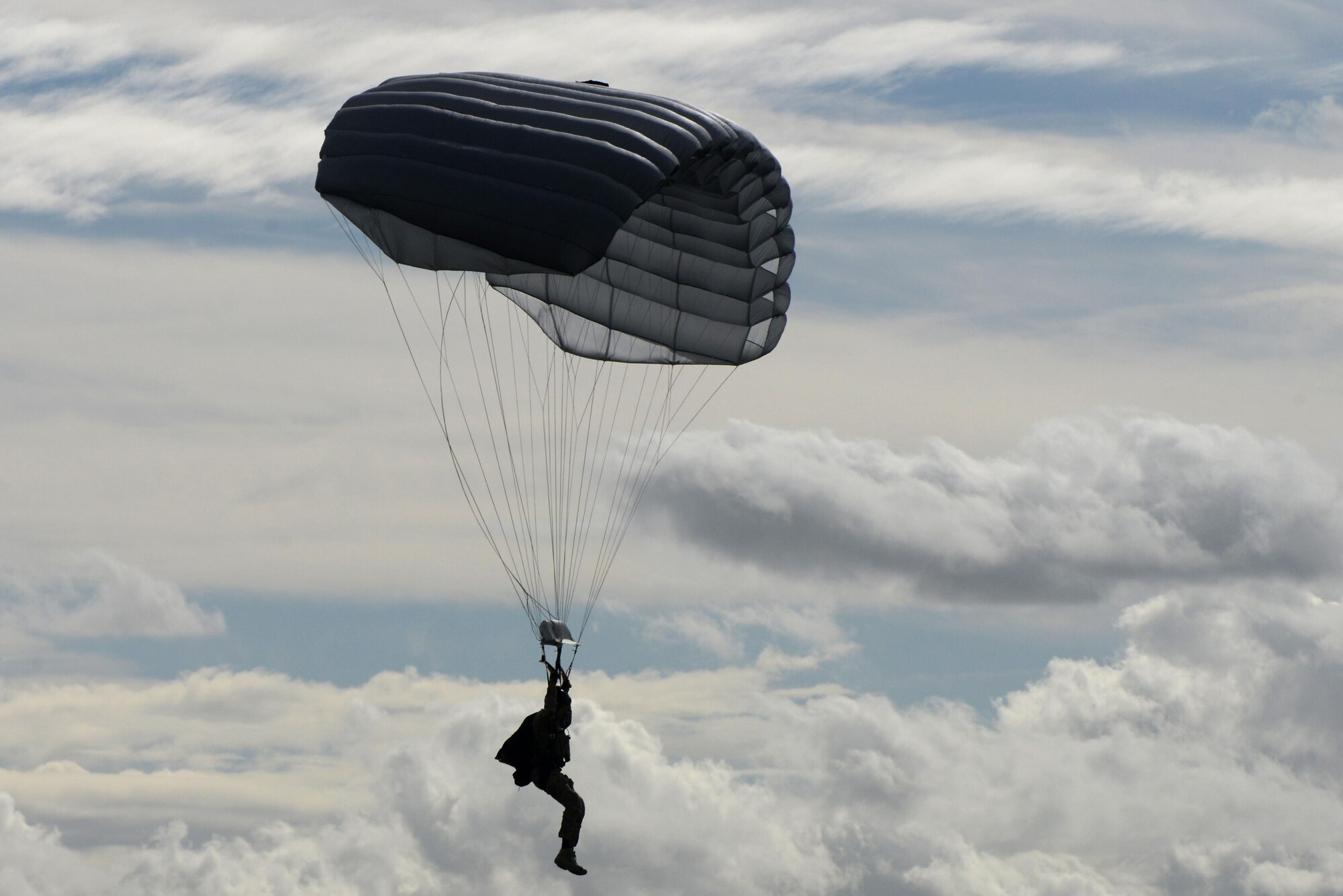 A U.S. Air Force pararescueman assigned to the 57th Rescue Squadron parachutes to the ground on Royal Air Force Lakenheath, England, Sept. 29. The jump was performed to demonstrate the life-saving capabilities of the 57th RQS. (U.S. Air Force photo/Airman 1st Class Eli Chevalier)