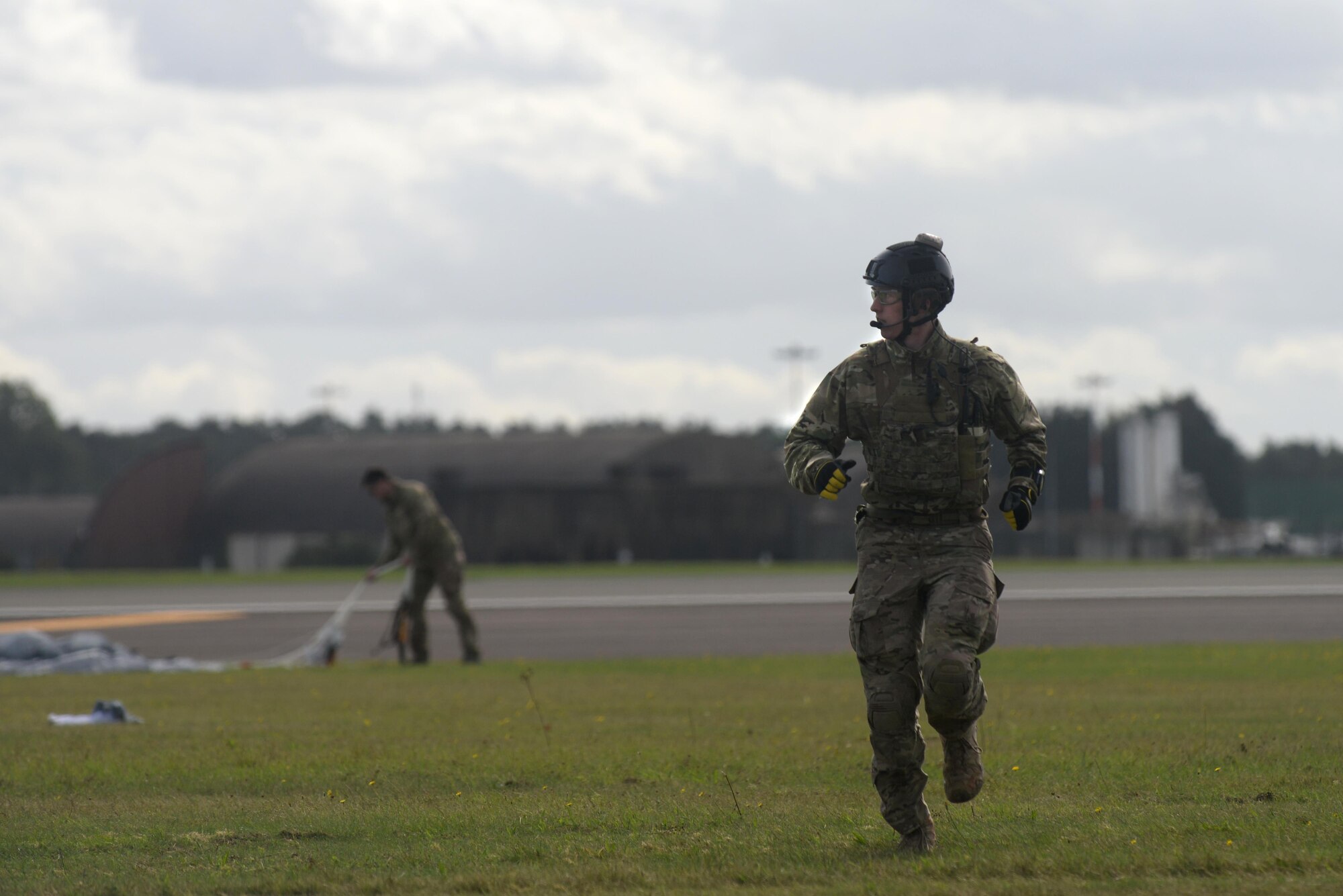 A U.S. Air Force pararescueman assigned to the 57th Rescue Squadron runs to the meeting point after parachuting into Royal Air Force Lakenheath, England, Sept. 29. The jump was performed to demonstrate the life-saving capabilities of the 57th RQS. (U.S. Air Force photo/Airman 1st Class Eli Chevalier) 