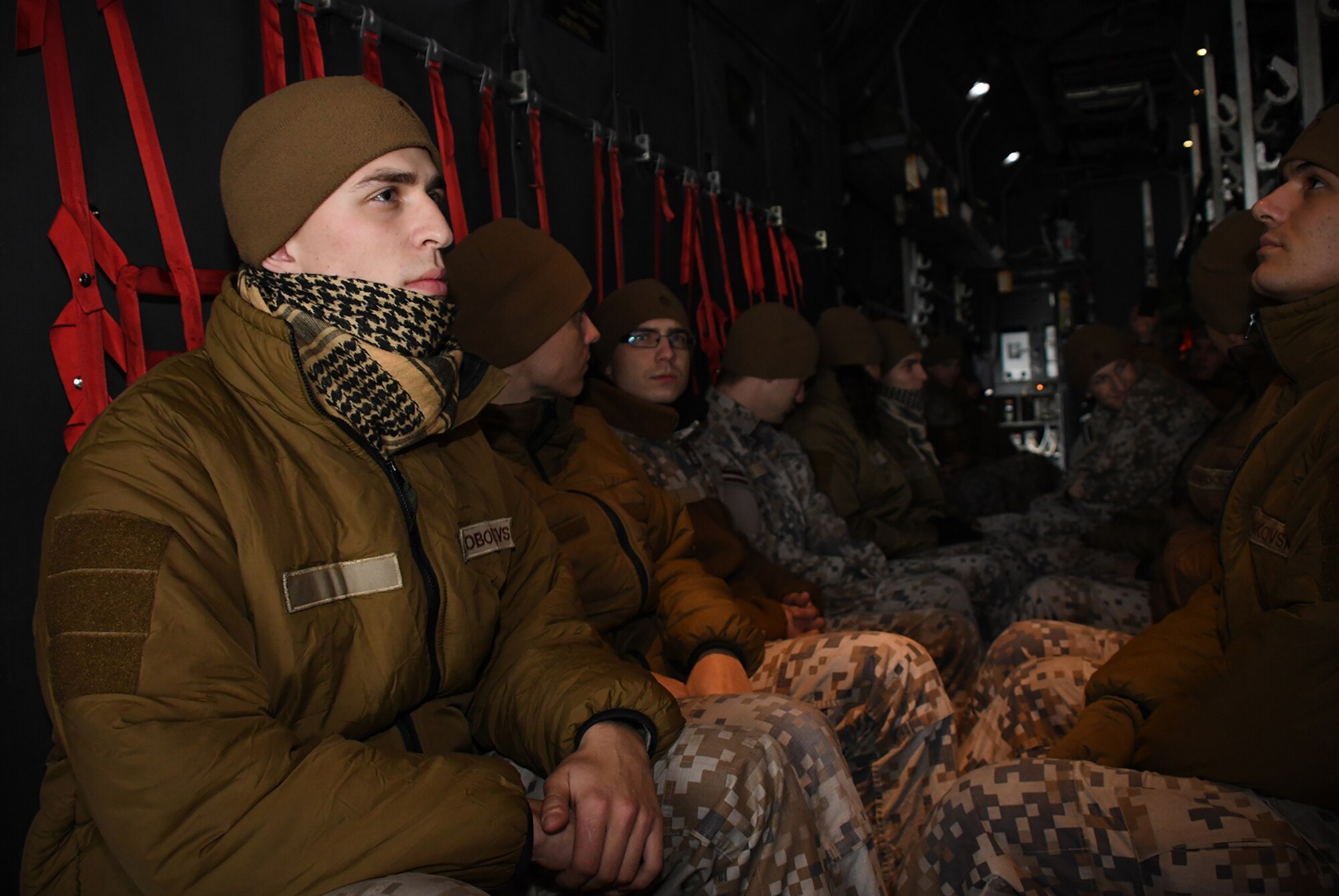 Latvian air force members sit in the cargo area of a C-130H from Dobbins Air Reserve Base, Ga., while parked on the runway at Lielvarde Air Base, Latvia, during Sky Fist, Oct. 6, 2016. Sky Fist was a bilateral, aircraft mishap training exercise designed to strengthen the partnership between the U.S. and Latvia. (U.S. Air Force photo by Staff Sgt. Alan Abernethy)
