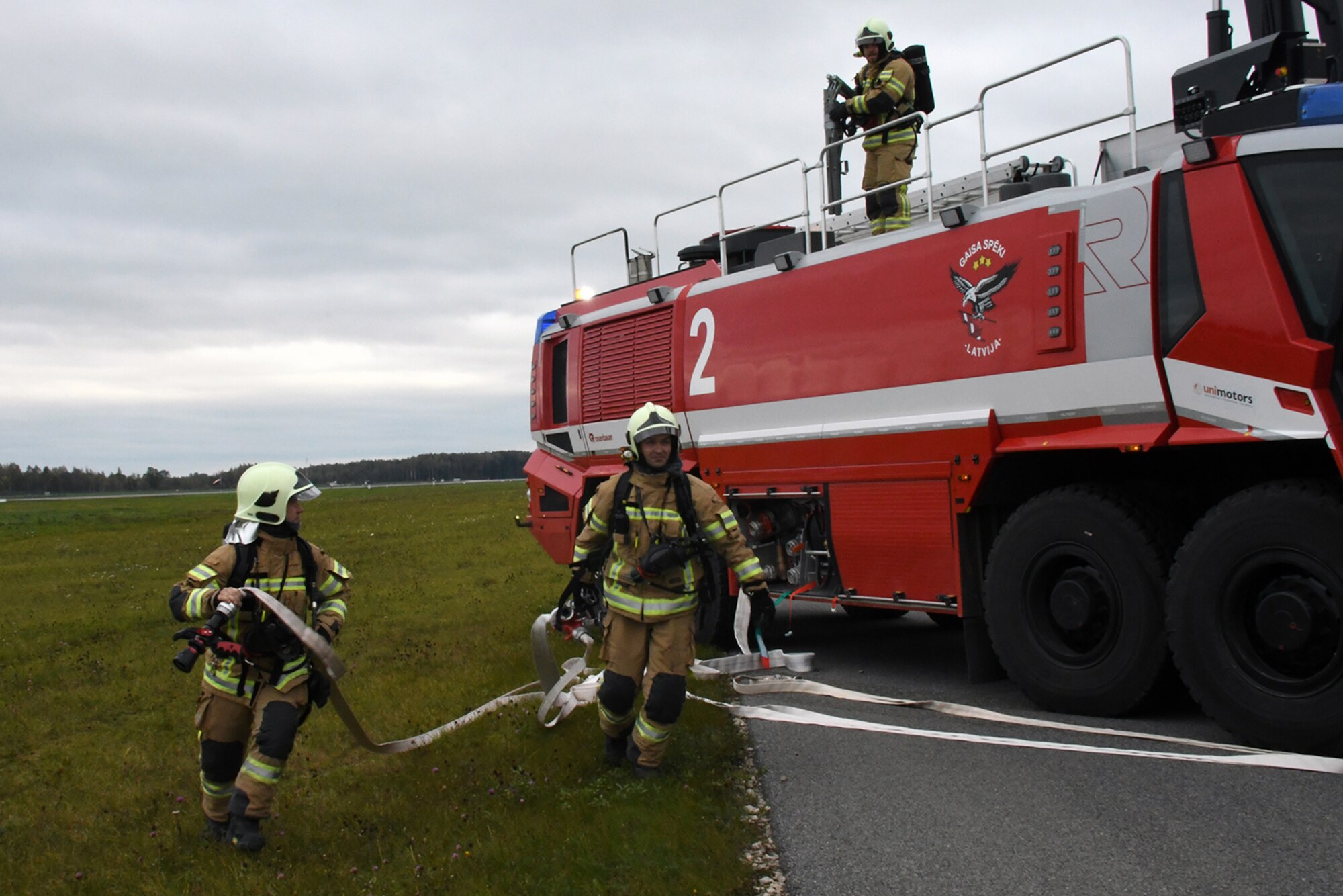 Latvian fire and rescue emergency responders arrive on the runway at Lielvarde Air Base, Latvia, where a C-130 from Dobbins Air Reserve Base, Ga. is positioned in a simulated crash during Sky Fist, Oct. 6, 2016. Sky Fist was a bilateral aircraft mishap training exercise designed to strengthen the partnership between the U.S. and Latvia. (U.S. Air Force photo by Staff Sgt. Alan Abernethy)