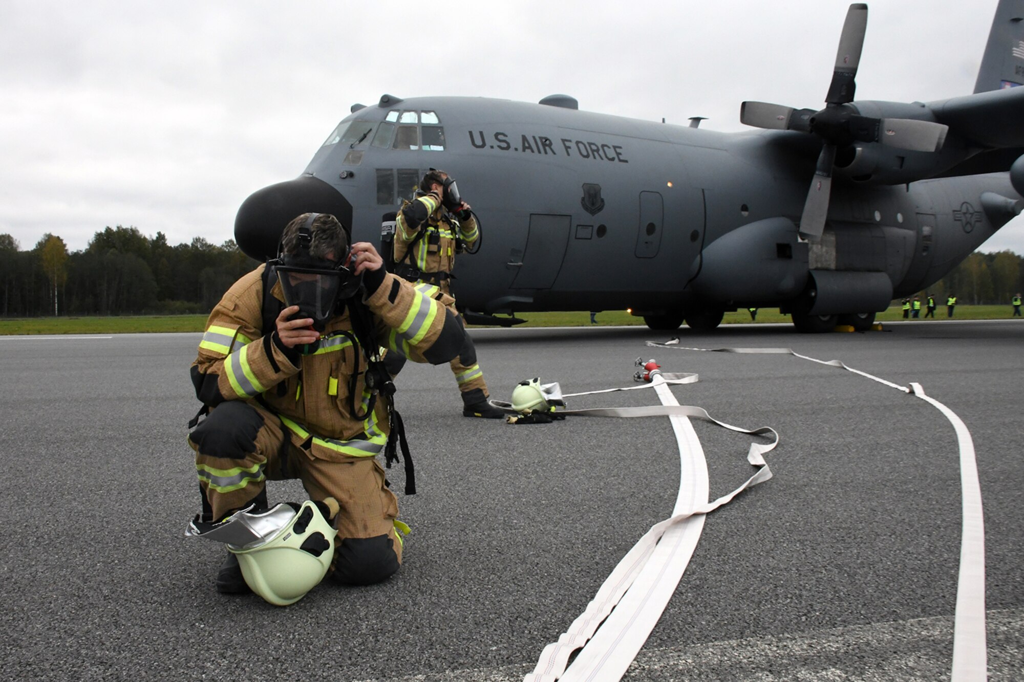 Latvian fire and rescue professionals arrive on the runway at Lielvarde Air Base, Latvia, where a C-130H from Dobbins Air Reserve Base, Ga. is positioned in a simulated crash during Sky Fist, Oct. 6, 2016. Sky Fist was a bilateral, aircraft mishap training exercise designed to strengthen the partnership between the U.S. and Latvia. (U.S. Air Force photo by Staff Sgt. Alan Abernethy)