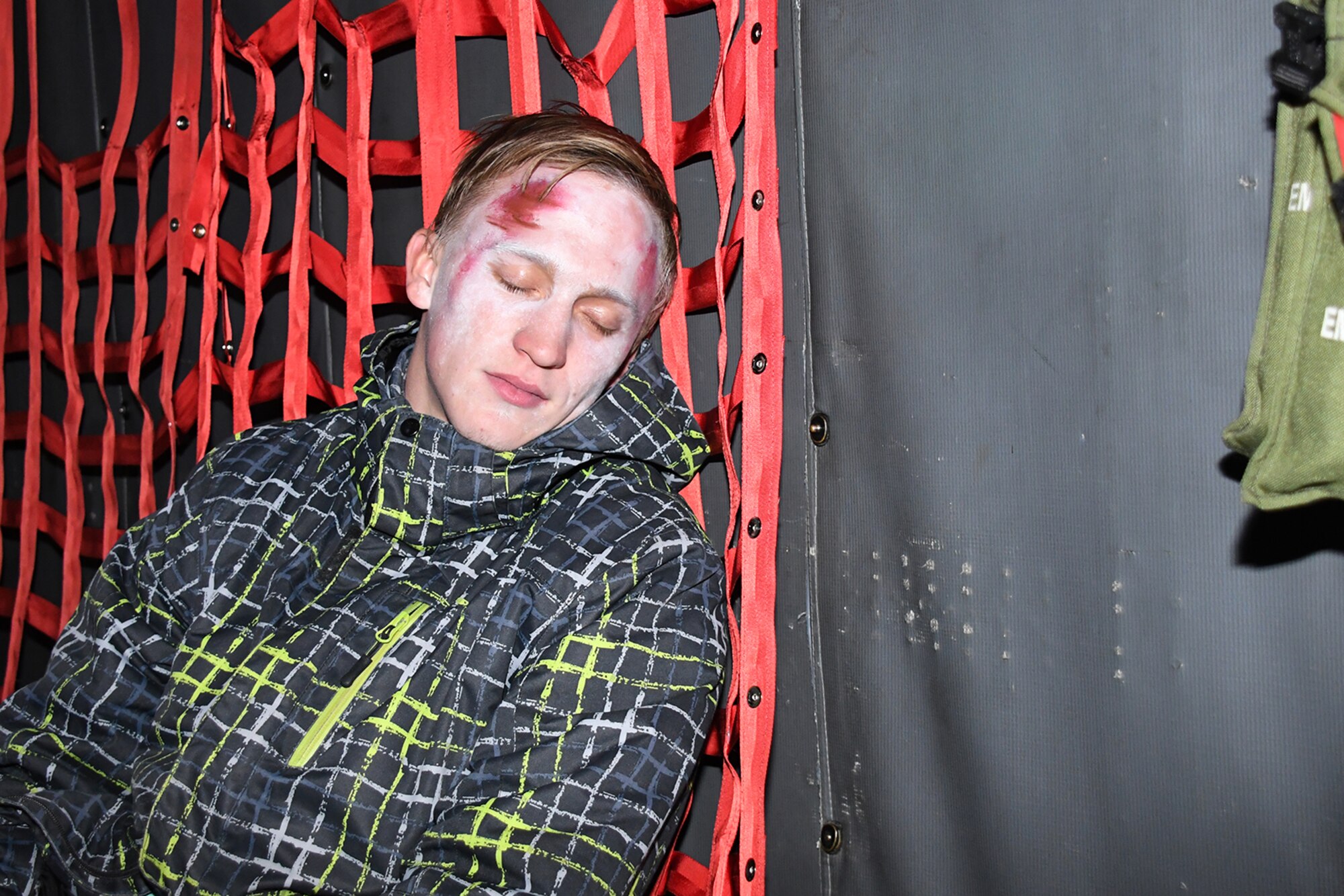 A participant in Sky Fist, an aircraft mishap training exercise at Lielvarde Air Base, Latvia, awaits rescue while in a 94th Airlift Wing C-130H during a simulated crash scenario, Oct. 6. 2016. Sky Fist was a bilateral exercise designed to strengthen interoperability and the partnership between the U.S. and Latvia. (U.S. Air Force photo by Staff Sgt. Alan Abernethy)