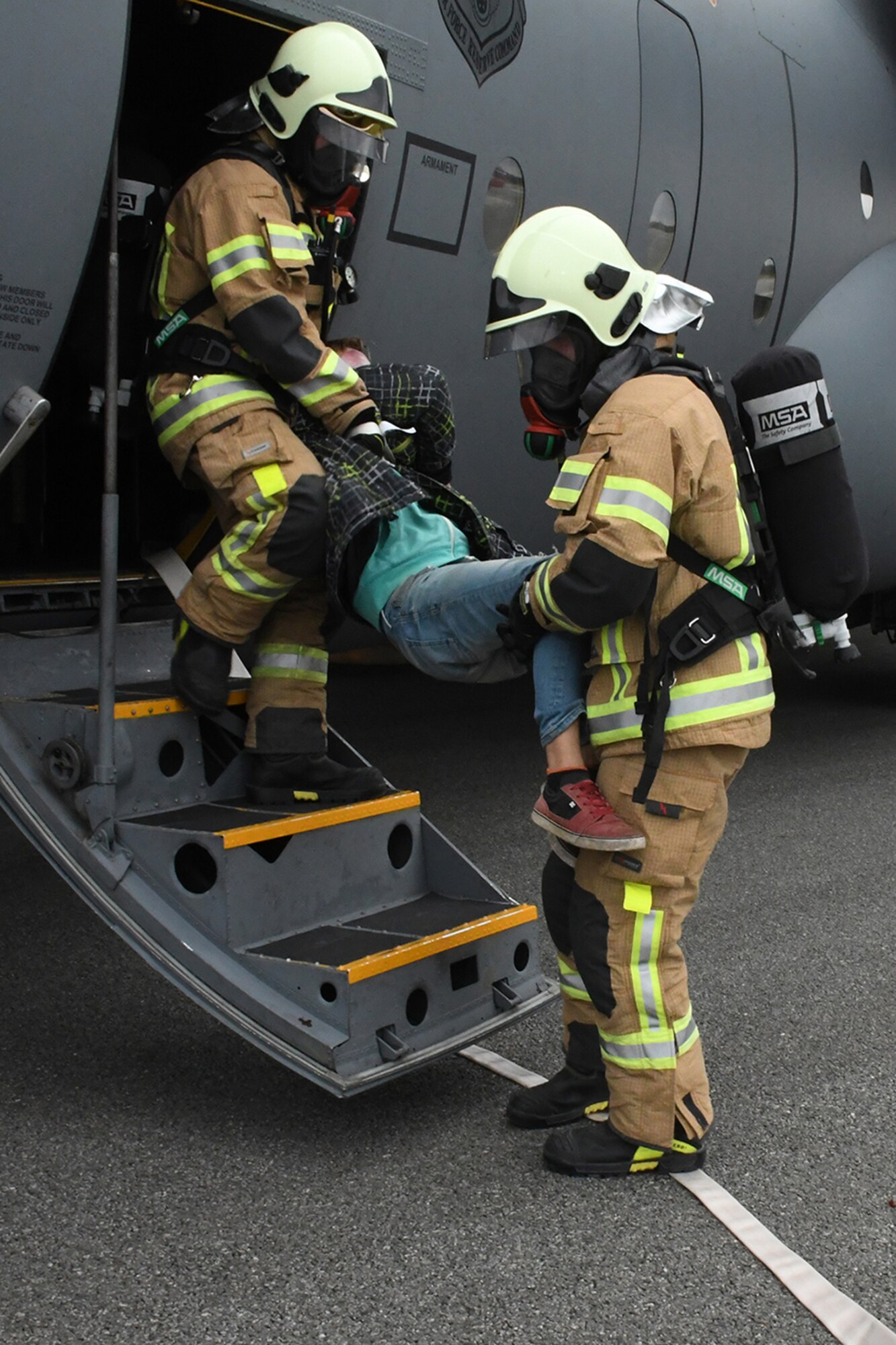 Latvian fire and rescue emergency responders evacuate an exercise participant from a C-130H from Dobbins Air Reserve Base, Ga., while positioned on the runway in a simulated crash at Lielvarde Air Base, Latvia, during Sky Fist, Oct. 6, 2016. Sky Fist was a bilateral aircraft mishap training exercise designed to strengthen the partnership between the U.S. and Latvia. (U.S. Air Force photo by Staff Sgt. Alan Abernethy)
