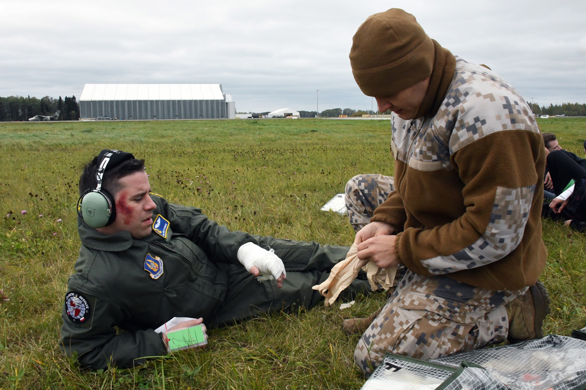 Senior Airman Joshua Stubbs, 700th Airlift Squadron loadmaster, receives simulated medical treatment from a Latvian air force medical technician during Sky Fist, an aircraft mishap training exercise, held at Lielvarde Air Base, Latvia, Oct. 6, 2016. Sky Fist was a bilateral exercise designed to strengthen the partnership between the U.S. and Latvia. (U.S. Air Force photo by Staff Sgt. Alan Abernethy)