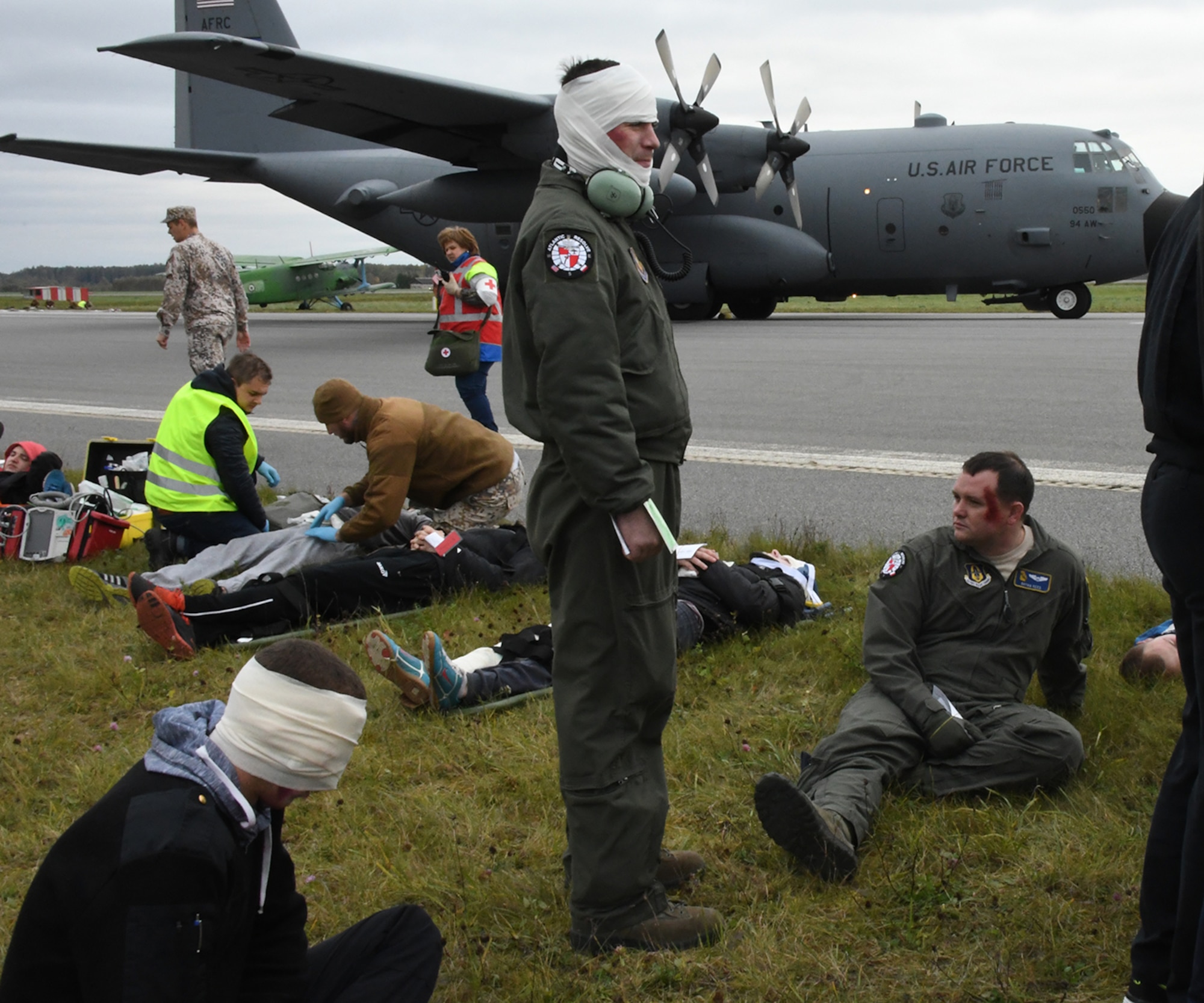 Senior Airman Joshua Stubbs, 700th Airlift Squadron loadmaster, and 1st Lt. Brian Reed, 700th AS pilot, join others with simulated injuries during Sky Fist, an aircraft mishap training exercise, held at Lielvarde Air Base, Latvia, Oct. 6, 2016. Sky Fist was a bilateral exercise designed to strengthen interoperability and the partnership between the U.S. and Latvia. (U.S. Air Force photo by Staff Sgt. Alan Abernethy)