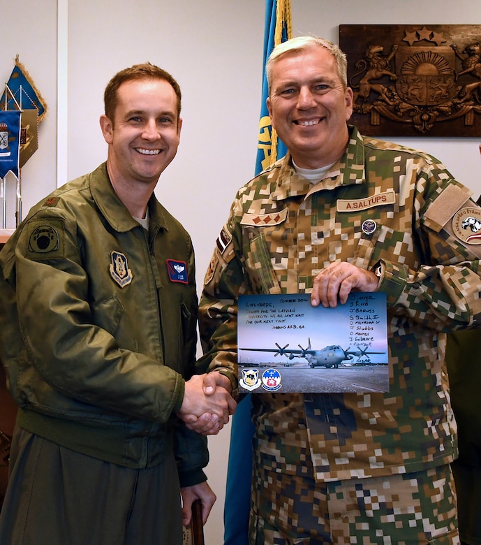 Maj. Jonathan Lester, 700th Airlift Squadron pilot, shakes hands with Col. Armands Saltups, Latvian air force commander, during Sky Fist, an aircraft mishap training exercise, at Lielvarde Air Base, Latvia, Oct. 6. 2016.  The 94th Airlift Wing from Dobbins Air Reserve Base, Ga., represented the U.S. Air Force in Sky Fist, a bilateral training exercise designed to strengthen interoperability and the partnership between the U.S. and Latvia. (U.S. Air Force photo by Staff Sgt. Alan Abernethy)