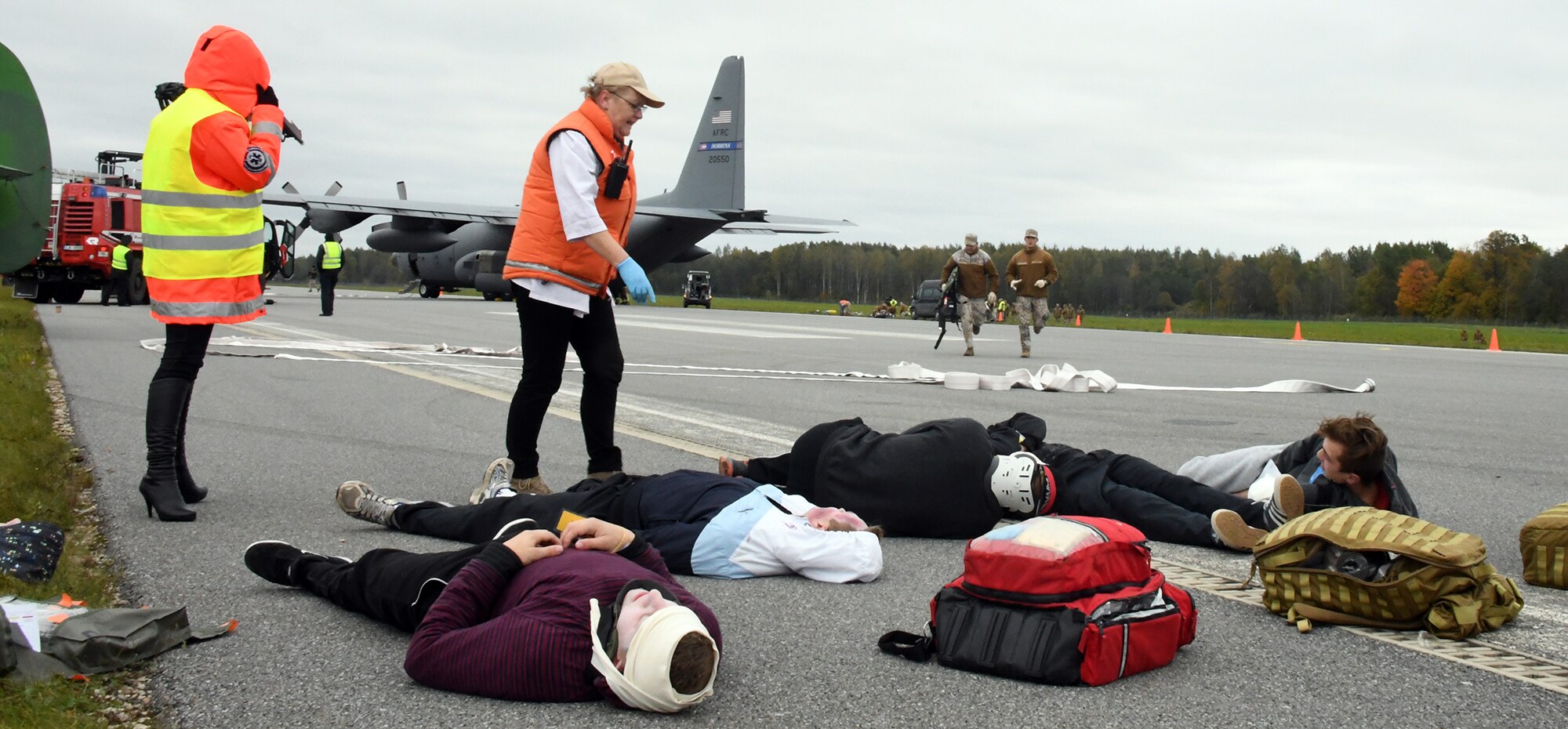 Latvian civil-military participants of Sky Fist, an aircraft mishap training exercise, held at Lielvarde Air Base, Latvia, await rescue during a simulated crash scenario, Oct. 6. 2016.  The 94th Airlift Wing from Dobbins Air Reserve Base, Ga., represented the U.S. Air Force in the bilateral training exercise designed to strengthen the partnership between the U.S. and Latvia. (U.S. Air Force photo by Staff Sgt. Alan Abernethy)