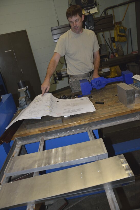 Blue prints being checked and re-checked by TSgt. Richard Towlson making sure the elevator support bracket is machined to the exact specifications. This newest Westover manufactured part will make the oldest C-5A in the fleet fully mission capable once again.