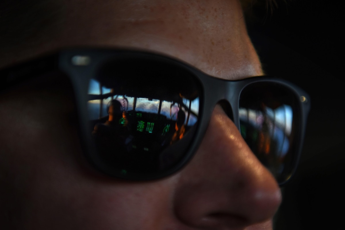 U.S. Air Force Senior Airman Mason Forbush, 19th Aircraft Maintenance Squadron crew chief, looks out onto the flight deck mid-flight on a C-130J headed to Haiti Oct., 8, 2016. The C-130J, flown by the 61st Airlift Squadron, delievered supplies and personnel as part of humanitarian effort to Haiti in the wake of Hurricane Matthew, a Category 4 hurricane. (U.S. Air Force photo by Senior Airman Mercedes Taylor)